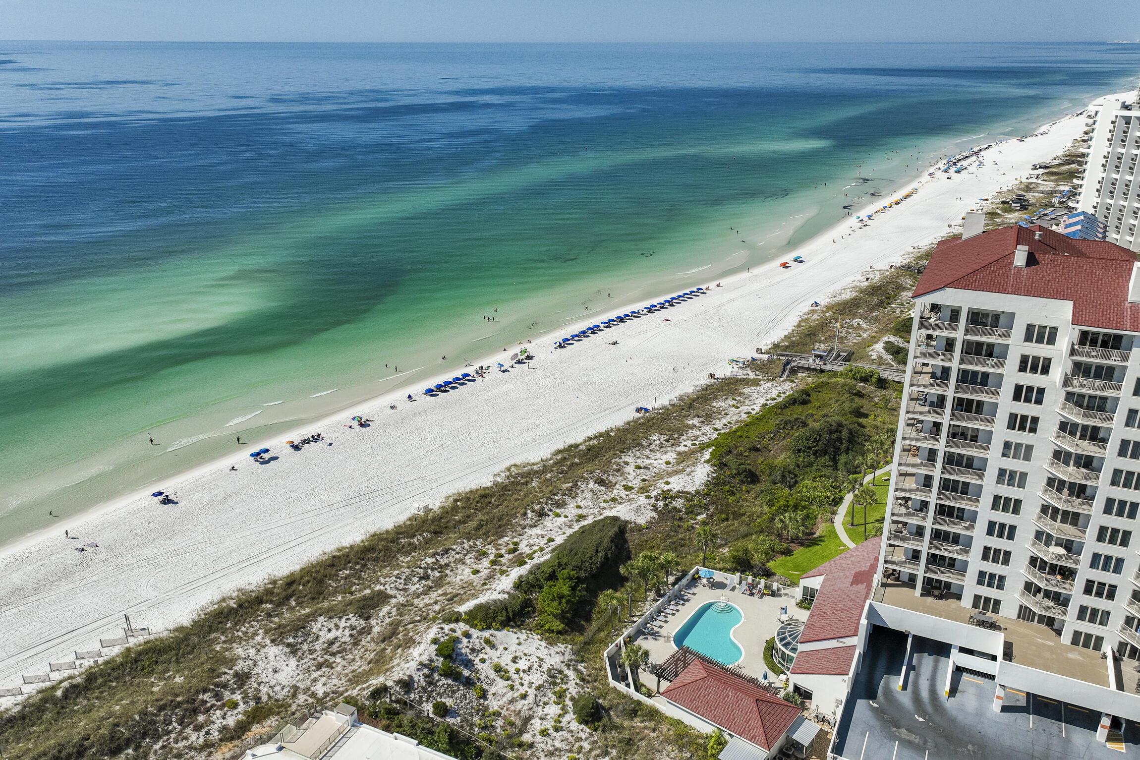 This east-facing unit offers a daily spectacle of Florida's stunning pink and orange sunrises. Easterly gulf views and a prime location await! The unit offers a fantastic canvas for customization and modernization, allowing you to create a stylish beach escape. The prime location and incredible views make this property a must-see for those looking to personalize their piece of paradise. Don't miss this chance to create your dream beach getaway.  Located in the 52 acre resort of Tops'l with all the best amenities with added membership fees.  Beach Manor has 5 levels of undercover parking. No assigned parking
