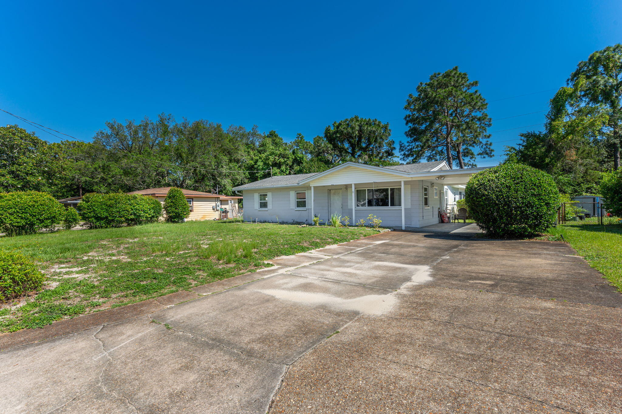 Property appraised for $300,000!~ Fantastic location in FWB with 4 true bedrooms! Two living spaces with wood laminate flooring. Formal dining room, and open kitchen concept make this a desirable floor plan. Kitchen features a breakfast bar, stove, built in microwave, dishwasher, and side by side fridge. Den area has a brick fireplace, built in bookshelves and tv stand, and ceiling fan. Master bedroom is a split floor plan design, featuring carpet, ceiling fan, and in suite bathroom. Master bathroom had a tile shower/tub combo. Additional three bedrooms and full bathroom in split plan. Outside has even more upgrades in store with a covered carport, workshop/storage with power in the backyard, exterior semi enclosed back patio, fenced backyard, and additional poured driveway space.