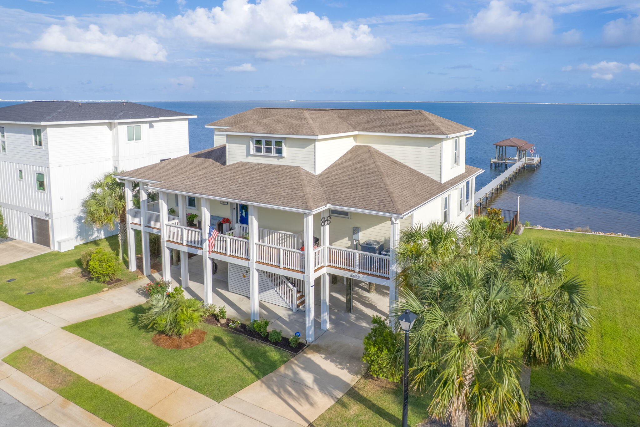 BRING ANY & ALL OFFERS! Welcome to your dream coastal retreat in the heart of Gulf Breeze, located in a quiet, waterfront neighborhood that continues to grow with luxury homes! This home has been meticulously updated and showcases exceptional detail throughout. Situated on the Intracoastal Waterway, the property features a sea wall, private boat dock with swim platform, boathouse, fishing station and remote controlled boat lift! The outdoor living spaces are remarkable, with a covered patio, outdoor TV and speaker system, open deck, fire pit area, and a fully fenced backyard. A hydraulic lift carriage provides easy access from the ground level to the main floor where you are greeted with a wraparound porch, which can take you to the front door, back door, and to the outdoor dining area! A n additional landscaped parcel is available next door.. Step inside to the open floor plan and stunning water views from nearly every room. The kitchen boasts granite countertops, an island, a brand new refrigerator, breakfast bar, Induction cooktop, and a walk-in pantry! The spacious living room is anchored by a fireplace with shiplap accents and includes a granite wet bar with a wine cooler and ice maker. A formal dining room on the main floor adds elegance for entertaining guests. On the main floor, the primary suite offers a private balcony, his-and-her walk-in closets with custom built-ins, and an en-suite bath with double granite vanities, a jetted whirlpool tub, tiled walk-in shower, and a private water closet. Three additional upstairs bedrooms each feature serene water views and share an oversized bath with a jetted tub, walk-in shower, and separate granite vanities. This home also features a new water heater, dehumidifier and two new HVAC systemsone for each floorboth just one year old.  Other features include accordion style storm shutters, an outdoor shower and workshop/storage area. Come see the amazing sunsets and don't miss the chance to own a piece of paradise!