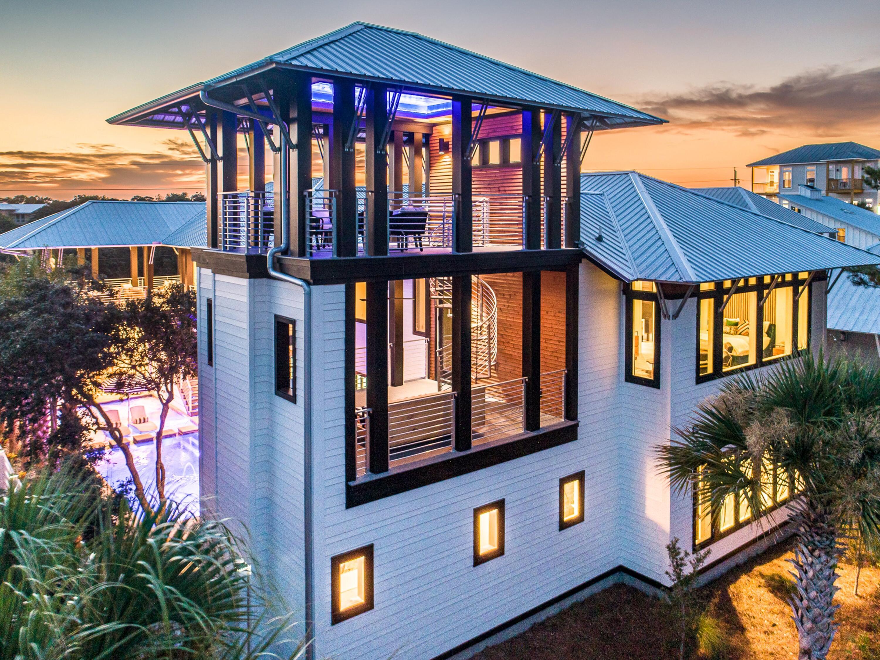 This iconic Dune Allen residence is equal parts private coastal retreat and enviable vacation destination. The home blends architectural artistry with professionally designed interiors to create a modern masterpiece that balances rustic warmth with contemporary style. 

Inside, a lavish kitchen with Wolf appliances and a 12-ft. Luke Langford dining table anchors the open floor plan, while a dramatic concrete fireplace adds character to the living space. Large windows flood every corner with natural light and frame tranquil views. Five suites, two bunk rooms, two laundry rooms, and multiple common areas make the home ideal for large family gatherings or group getaways. Step outside to a private courtyard where the pool and spa are enhanced by fountains, a sun shelf, and swim-up seating. Porches on every level invite moments of relaxation, from a grilling porch off the kitchen to a cozy sleeping porch with fireplace. The watchtower lounge crowns the home with sweeping panoramas. A two-car garage with climate-controlled storage adds convenience for long stays. 

Perfect for entertaining or unwinding, this home also shines as a vacation rental, sleeping up to 22 guests. The outdoor oasis features a summer kitchen with built-in grill, poolside smart TV, mini fridge, table tennis, spa and a pool with optional heater. Just a two-minute stroll to the beach, owners and guests alike will enjoy parking, services, and easy access to the best of 30A.

Just steps away, the Dune Allen beach access offers over 220 feet of pristine beachfront with restrooms for convenience and a lifeguard station for added peace of mind.