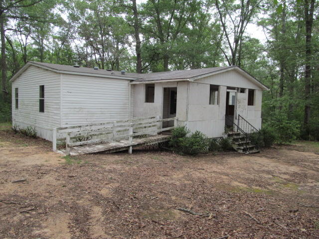 REO. 3 bedroom 2 bathroom mobile home located on 1 acre! Home needs TLC. Property is located on a paved road and features a detached carport. Call today to schedule your tour. Property sold 'as-is.''