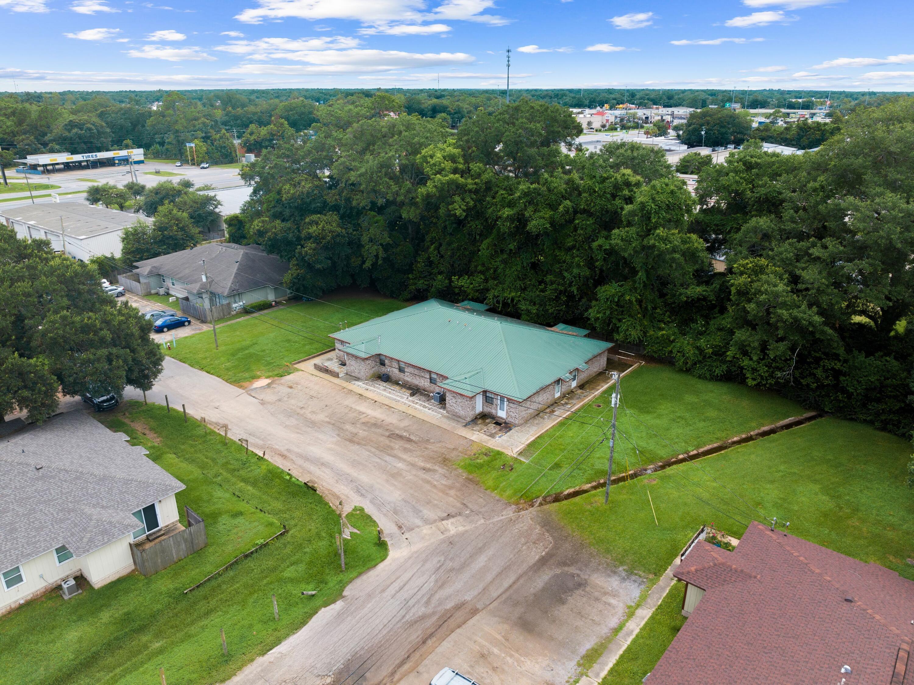 Discover an exceptional investment opportunity with this fully-rented four-plex in Pensacola, generating a robust monthly income of $4,435. This eight-bedroom, four-bathroom property spans 3,700 square feet and is perfectly situated in a prime location, making it an attractive prospect for savvy investors. With a durable brick exterior and a sturdy metal roof, this property is designed for low-maintenance living. The absence of carpet throughout ensures easy upkeep and longevity. Each unit is well-maintained, offering a reliable and consistent income stream. Ideal for investors looking to expand their portfolio, this four-plex combines the appeal of a great location with the security of a fully occupied rental property.