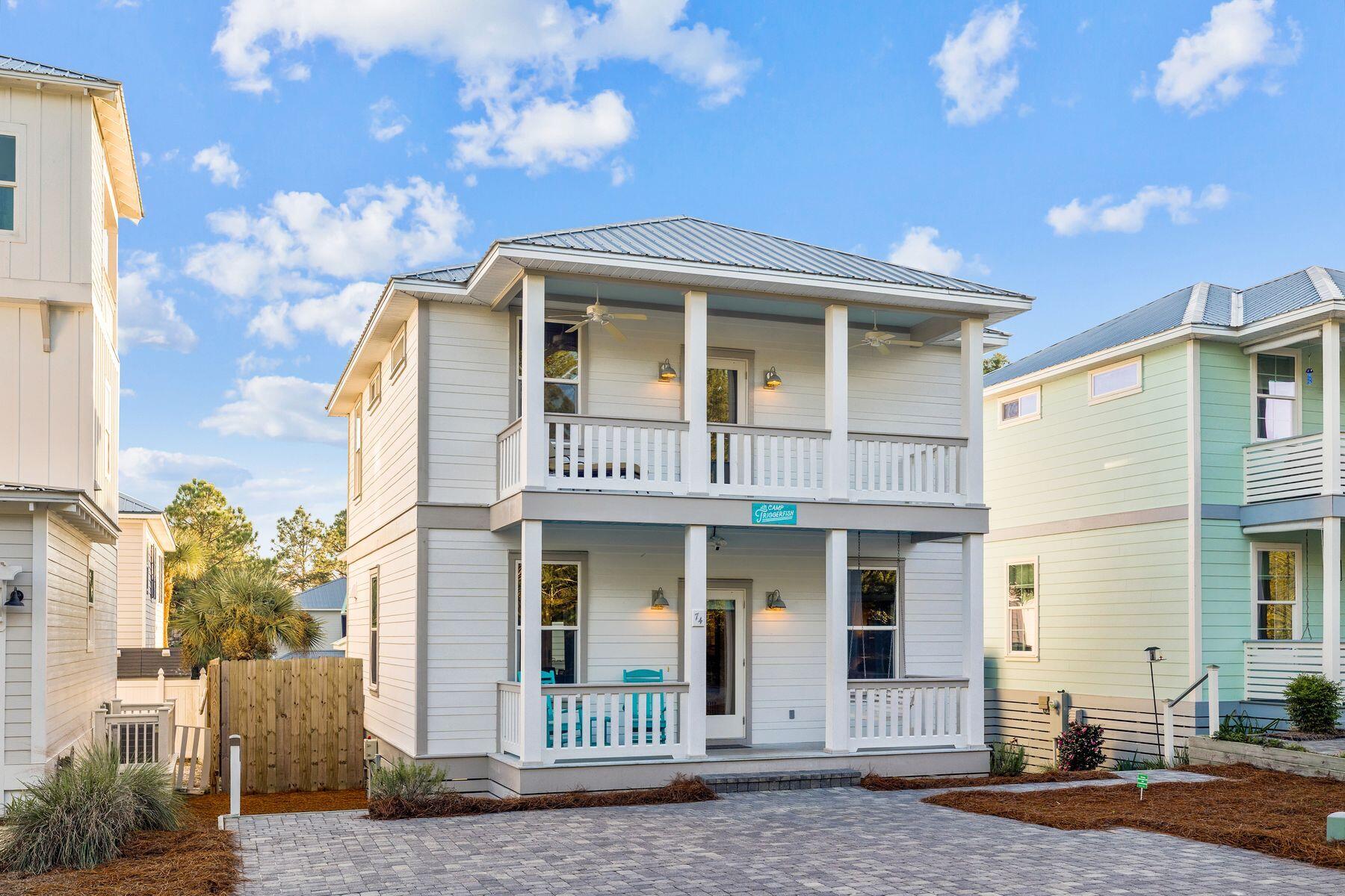 Introducing 74 Triggerfish Street—an inviting coastal retreat that captures the effortless charm of Blue Mountain Beach along iconic Scenic Highway 30A. Blending comfort, convenience, and a coveted walk-to-everything lifestyle, this thoughtfully designed cottage stands out with its oversized backyard, newly refinished decks, abundant parking, and quick access to not one but two beloved beach access points: Blue Mountain Beach and Gulfview Heights. Step inside to an open, sunlit layout that feels instantly welcoming. The main level flows beautifully, with a relaxed gathering space and well-appointed kitchen designed for laid-back coastal meals. A first-floor bedroom adds versatility and ease for guests, family members, or those who prefer single-level living. Upstairs, the expansive primary suite becomes a true retreat with its generous walk-in closet, spacious en suite, and private covered balcony perfect for morning coffee or evening unwinding. Two additional guest rooms with a shared full bathroom complete the second level, offering plenty of room for everyone. Outdoors, the home truly elevates the 30A lifestyle. The large backyard with privacy fencing provides the perfect setting for grilling, gathering, or relaxing after a day on the sand. An outdoor shower, storage beneath the home, and ample parking add even more convenience for beach lovers and adventure seekers alike. Owners also have the option to join The Village at Blue Mountain Beach, gaining access to a resort-style pool and fitness center just steps from the front door. Perfectly placed among Blue Mountain's favorite local hotspots, you're moments from Mimmos Ristorante Italiano, 30A Thai, The Coffee Shoppe, Basmati's Asian Cuisine, Redfish Taco, Cowgirl Kitchen, Blue Mountain Bakery, For the Health of It Organic Grocery and Juice Bar, Shunky Gulley Oyster Bar, and Papa Surf Burger Barputting great dining, coffee, and entertainment right at your fingertips. Whether you're seeking a full-time coastal haven, a relaxing second home, or a lucrative investment, 74 Triggerfish Street delivers the ideal blend of charm, walkability, and laid-back luxury that defines life along Scenic 30A.
