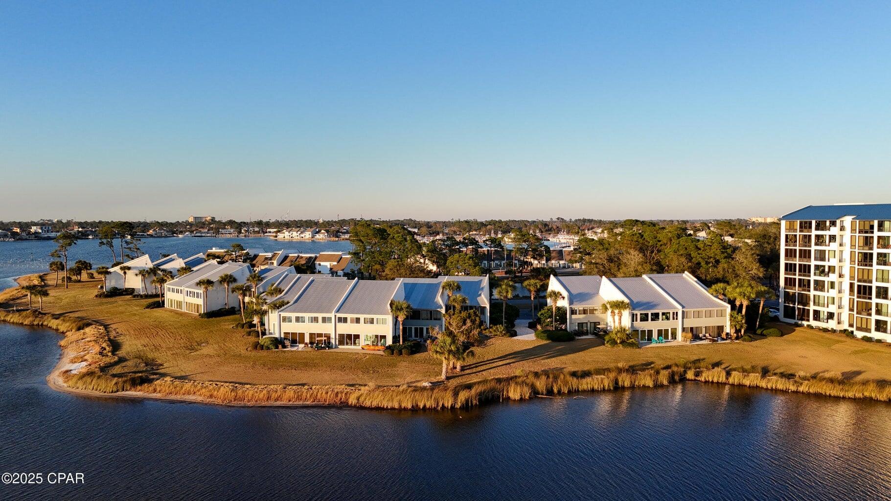 This completely renovated Bayview Villa is located in Bay Point and overlooks Grand Lagoon and St. Andrews State Park. Prior owner is a renowned Bay Point builder and upgraded the entire unit to an exacting standard. The nickel gap shiplap is found throughout with flush mount recessed lighting and slicked ceilings. The windows are floor to ceiling overlooking the bay and providing abundant light. Kitchen cabinets, counters, backsplash, and appliances have all been updated. Subway tiles are used in bath and kitchen. The units floor plan has been modified to provide a pantry and more efficient use of closet area. While there are NO rental restrictions, this unit has never been rented short term by current owner. Bayview consist of four buildings totaling 40 units. There is a community dock that allows owners to keep boats at the dock with temporary trailer parking. Bayview is financially sound and is not required to meet current statutes facing condos three stories and above. Even so the association is funded with healthy reserves. 400 a month condo fees is one of the lowest on the beach and in Bay Point. There is also golf cart parking on the sides of each building to keep carts. Point South Marina is around the corner for larger boats. Bay Point is a gated community with 24-hour roving security, an 18-hole Nicholas Golf Course, tennis courts, resort hotels, with several restaurants and bars.