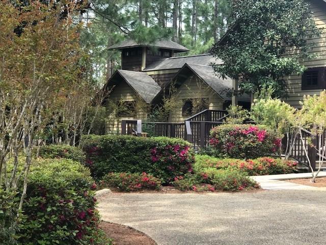 Own your own private resort-like oasis and spa as you cross your own private bridge into a secluded sanctuary. This exquisite, custom built and hand crafted luxury home, has impeccable architectural characteristics and comes complete with the utmost details, including a 10 foot mahogany front door, slate flooring through an impressive foyer which gives way to a two-sided gas fireplace with a custom mantle between the grand dining and living rooms that showcases beautiful hardwood flooring, tremendously high ceilings that complete the whole house, floor to ceiling windows in the massive living room that overlooks the backyard oasis, a resort style pool with a custom stone waterfall and planters and the many decks that overlook the 8th hole of the acclaimed Greg Norman's Shark's Tooth Golf Course. The gourmet kitchen boasts Sub Zero refrigerator/freezer, Wolf gas six burner/double oven with Viking pro series range hood, two Asko dishwashers, a sub-zero wine cooler and the kitchen boasts a 12'x4' large marble island. There are cedar lined master closets off of the magnificent master bedroom and the master bathroom features tile floors, deep garden tub, a large glass shower with body sprayers, back-to-back travertine vanities and a unique double-sided mirror. There is a beautifully custom mahogany spiral staircase that leads to an extra bedroom or study and two guest bedrooms with ensuites are located on the other side of the house, giving everyone privacy and access to the backyard. More upgrades include a fully finished, climate controlled two-car garage plus separate golf cart garage, two Rinnai tank-less water heaters, copper gutters, 8' tall solid wood doors, media room with electronics and Sonos System with speakers throughout. The Gated Wild Heron community has a gorgeous pool, Fitness Center and Boat House on Lake Powell for everyone's enjoyment. This famously known gated community is just minutes from Rosemary Beach, 30A, six miles from the future University Hospital and only a mile and a half from the beautiful Gulf of Mexico!