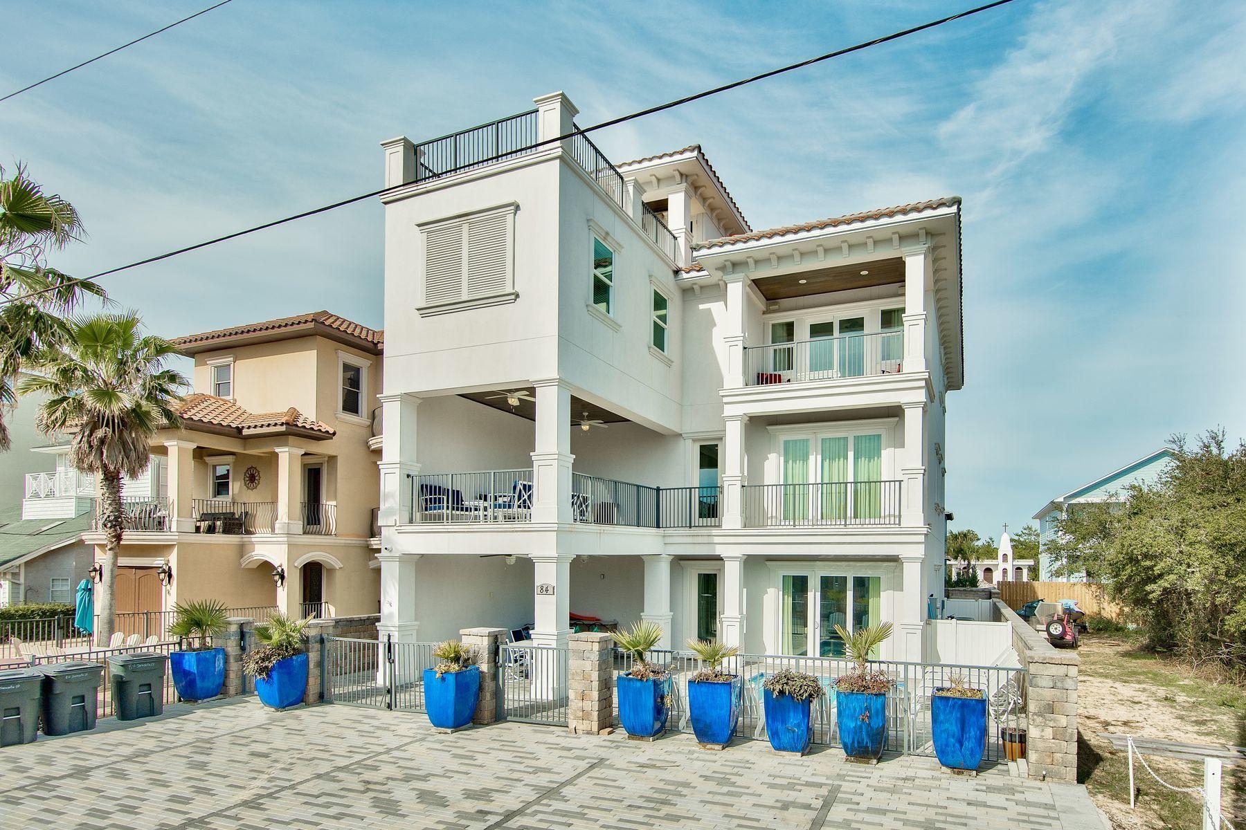The grandeur, beauty and magic of an exquisite lifestyle are all present in this magnificent seven-bedroom, eight-bath home. The one block walk to deeded beach access takes mere minutes. Cruising up to your fourth floor rooftop deck with coffee and a croissant, wine and cheese, family and friends or for a solo view over the emerald green waters of the Gulf of Mexico soothes and refreshes everyone. In three stories of fine craftsmanship and thoughtful design, this home offers sleeping space for 24, a glorious media room with a wet bar and large first floor entertainment and game area. First class is a way of life with no HOA fees and 1,000 square feet of outdoor deck space. The classy pool and spa by Watermark Pool & Spa is heated and flanked by expansive paver patio space, covered and open. Entertaining is a breeze indoors or outside near the pool, outdoor kitchen or gas fireplace. The kitchen is a gourmet's delight with top-of-the-line appliances. Crown molding, elegant window treatments, granite, marble and glass, hardwood floors, large windows and dazzling chandeliers all point to uncompromising quality. The property exudes a contemporary appeal for its gleaming white stucco exterior with a hint of Old World in the red tile roof.