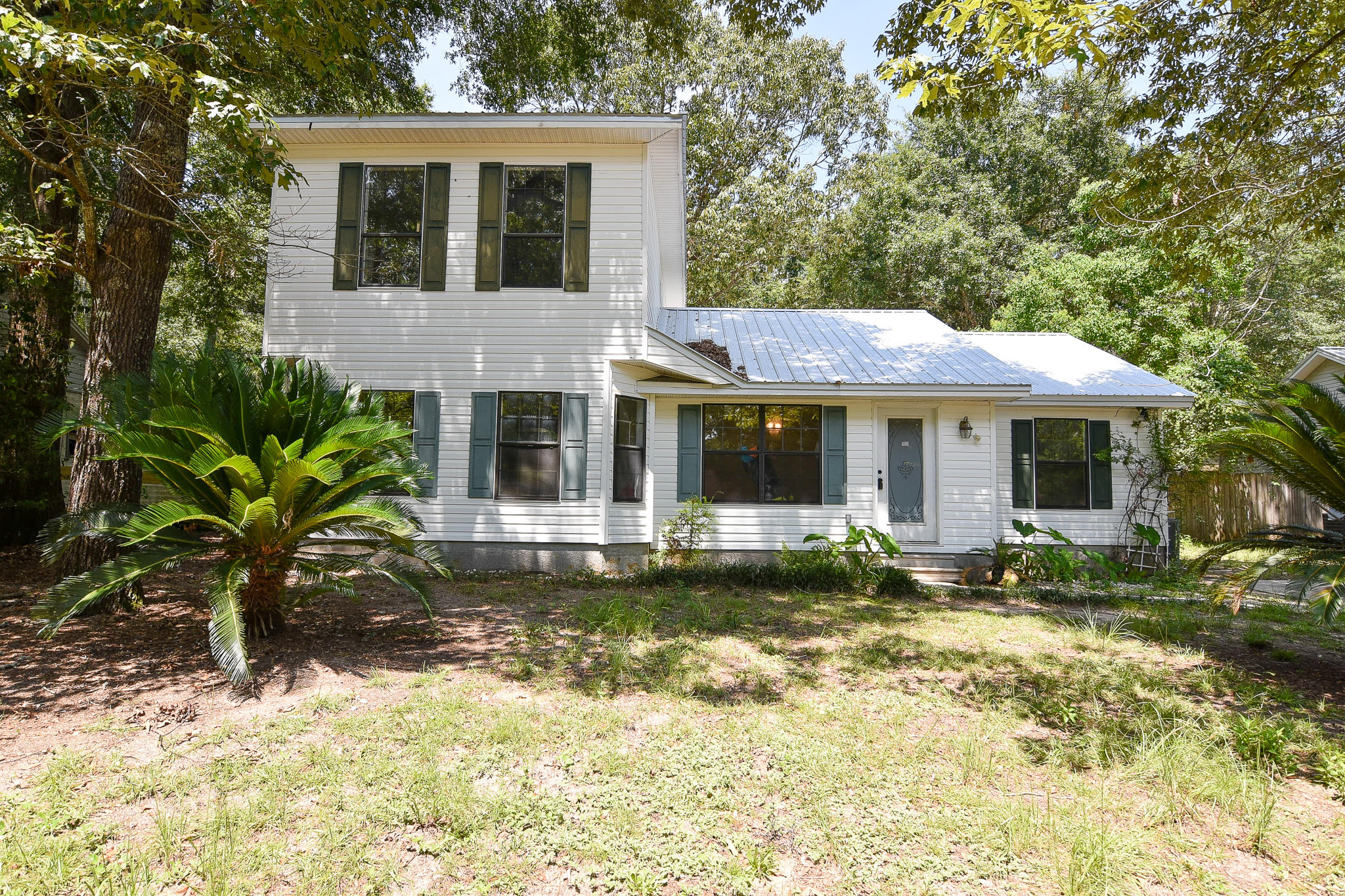 This cute home is ready for lucky new owners! In a cosy small cul du sac street, this 4 bedroom home is very special. In addition to being on a large lot, the home features a big kitchen and beautiful real wood floors in the main living areas. There are lots of cabinets in the kitchen, so storage is not a problem. Brand new carpeting is in all 4 bedrooms and the entire interior has been freshly painted! A new metal roof was installed last year, so nothing to worry about for years to come! My favorite part about this home? The entire upstairs is an enormous master bedroom retreat! Romantic and relaxing, the bedroom is huge, the walk in closet very large and the bathroom looks like it is from a spa! You must see this home to appreciate it! You won't find anything else like it at this price!