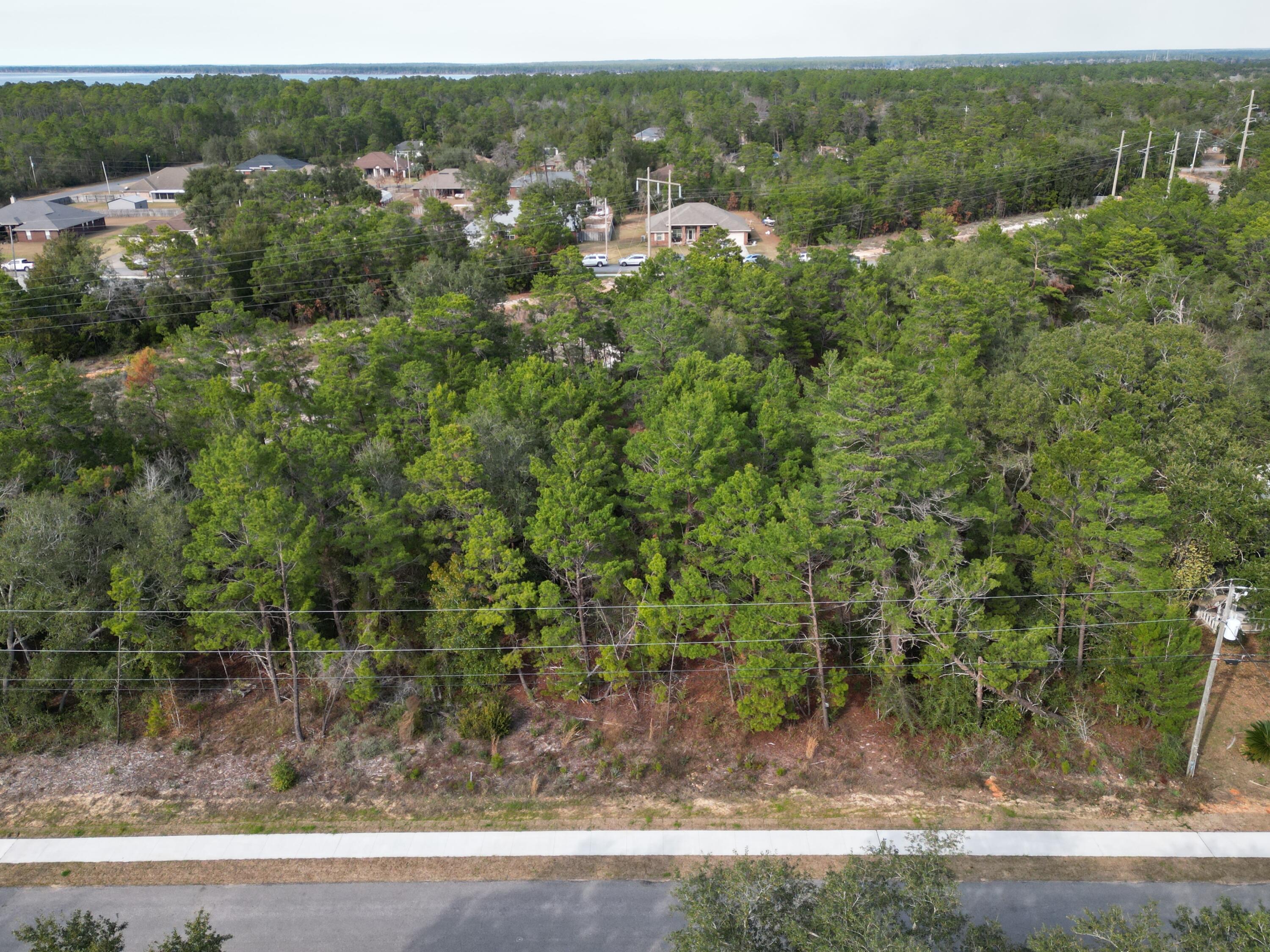 ATTENTION anyone looking for land to build a single family home on. This 1.17 acre lot in Holley by the Sea is one of the only high and dry lots left in HBTS left to build on, NO WETLANDS. The county has a new sidewalk project in HBTS currently underway, which has already been developed in front of this lot offering family / pet walks, uninterrupted exercising purposes, and a short walk for the kids to the new K-8 school at the end of Federal street. There is an HOA annually, which has numerous benefits such as: a club house with pools, gym, fishing, 48 acre park, Handball courts, 8 tennis courts, basketball courts, baseball field, RV parking, picnic area, playground, and much more. Hidden Creek Club is minutes away offering 18 holes of golf on one of Florida's top courses.  Survey available. 
Electric pole present and water tap present.