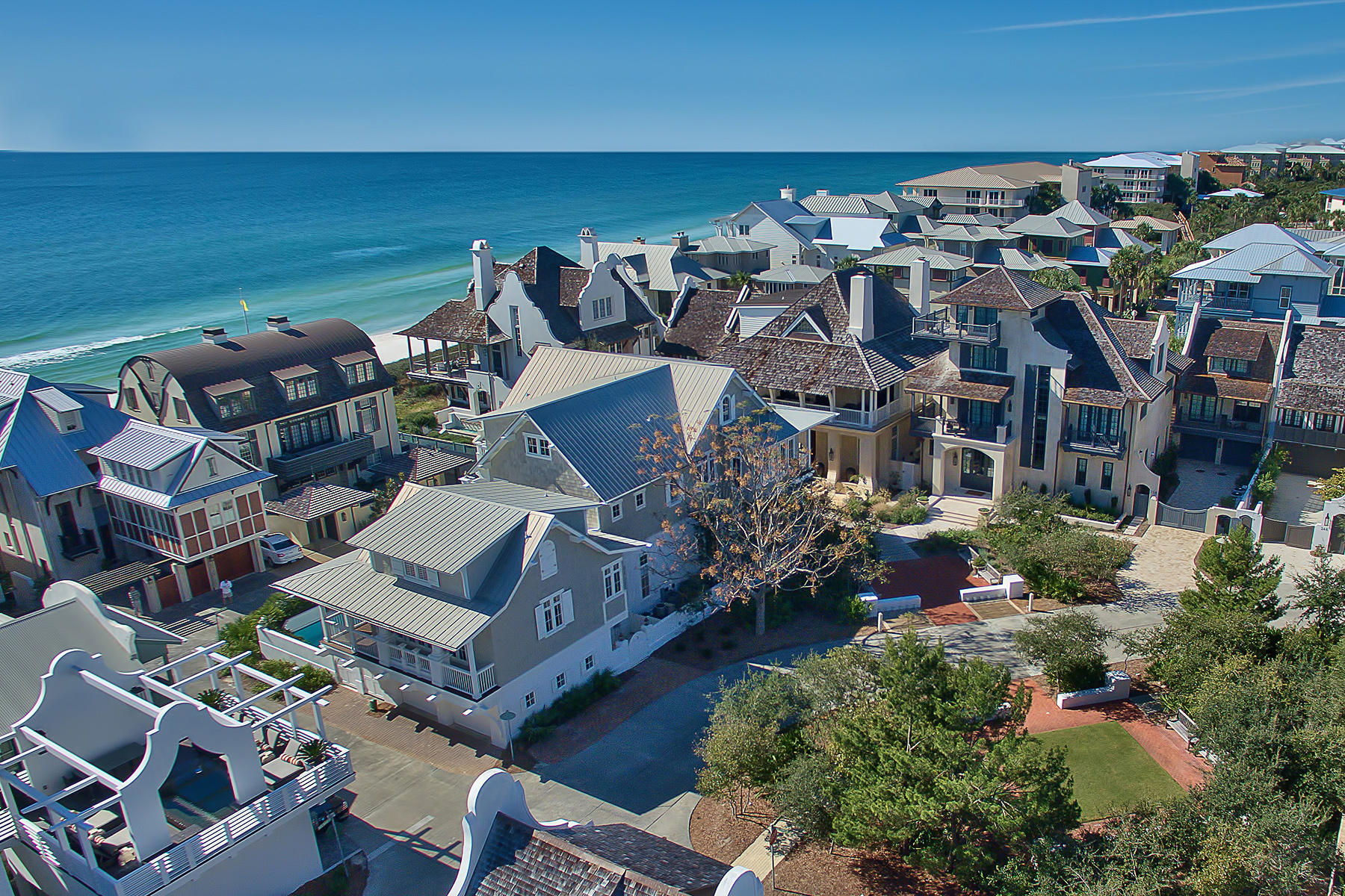Just one off the gulf with direct gulf views, this double lot compound enclosed by masonry wall is truly a rare find in Rosemary Beach.
This 'Cape Cod Grey and White' iconic landmark at the West Water Street curve impressively stands out. With no direct bordering neighbors on all four sides, this estate compound comprises seven bedrooms with three master suites for a total of 20 guests.
Expansive porches and balconies of over 1500 square feet open onto the sounds of waves and crisp gulf air. The enticing courtyard pool anchors your property.
The second floor living room, with vaulted ceilings, is positioned to capture an abundance of light. A vibrant kitchen features new quartz countertops and lovely gray backsplash. The private dining room fills with light and is ideal for a family Thanksgiving dinner. 
With high ceilings, the first floor features two master suites and two bunk rooms, all with en-suite baths.
A third master bedroom is located on the second floor. 
The third floor offers billiards, media room and bedroom options. The elevator services all three floors. 
A spacious carriage house is a getaway in itself. The full carriage kitchen overlooks the park and a sizable living area looks gulf-ward. Privacy abounds, yet so close is Rosemary Beach's walk-able cafes and local hotel.
The enclosed pool courtyard offers two outdoor showers, bathroom and covered seating. 
Enjoy the Rosemary Beach lifestyle and scenic 30-A's golf, food and art.