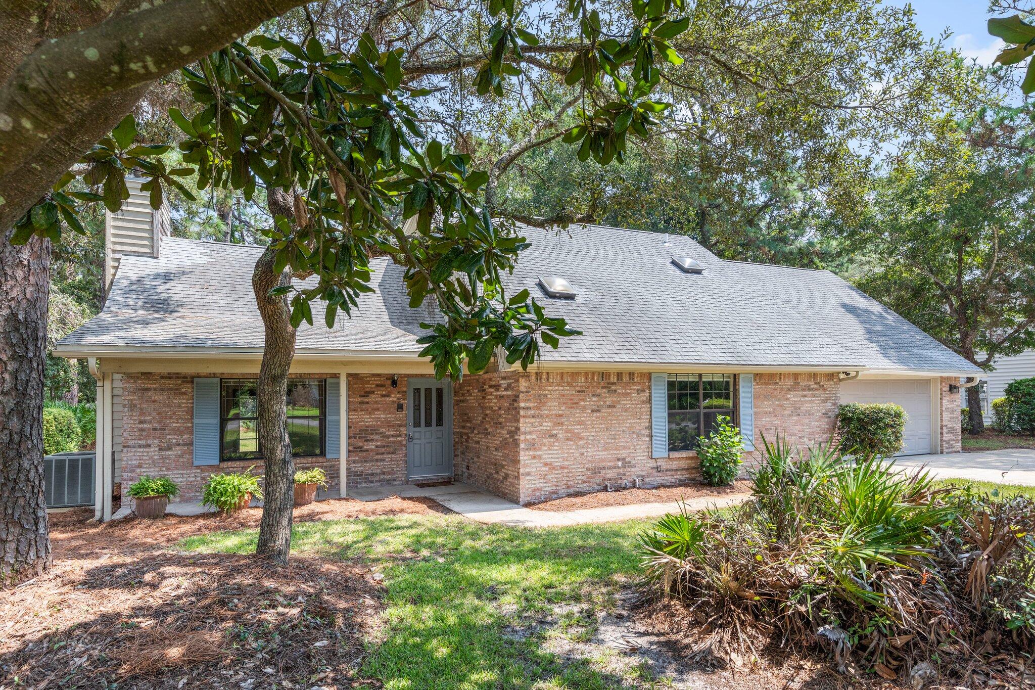 Settle into this charming 4bd/2.5ba home within the desirable Bluewater Bay community. Tall ceilings and a log burning fireplace add space and comfort to the inviting living area. Primary bedroom favorably located on the main floor extends to the primary bath which shows off the large garden tub and vanity. Upstairs is complete with three bedrooms and a full bath. Plenty of outdoor space for recreation, entertaining, or just enjoying the Florida sun await you in the lush landscape of this property!