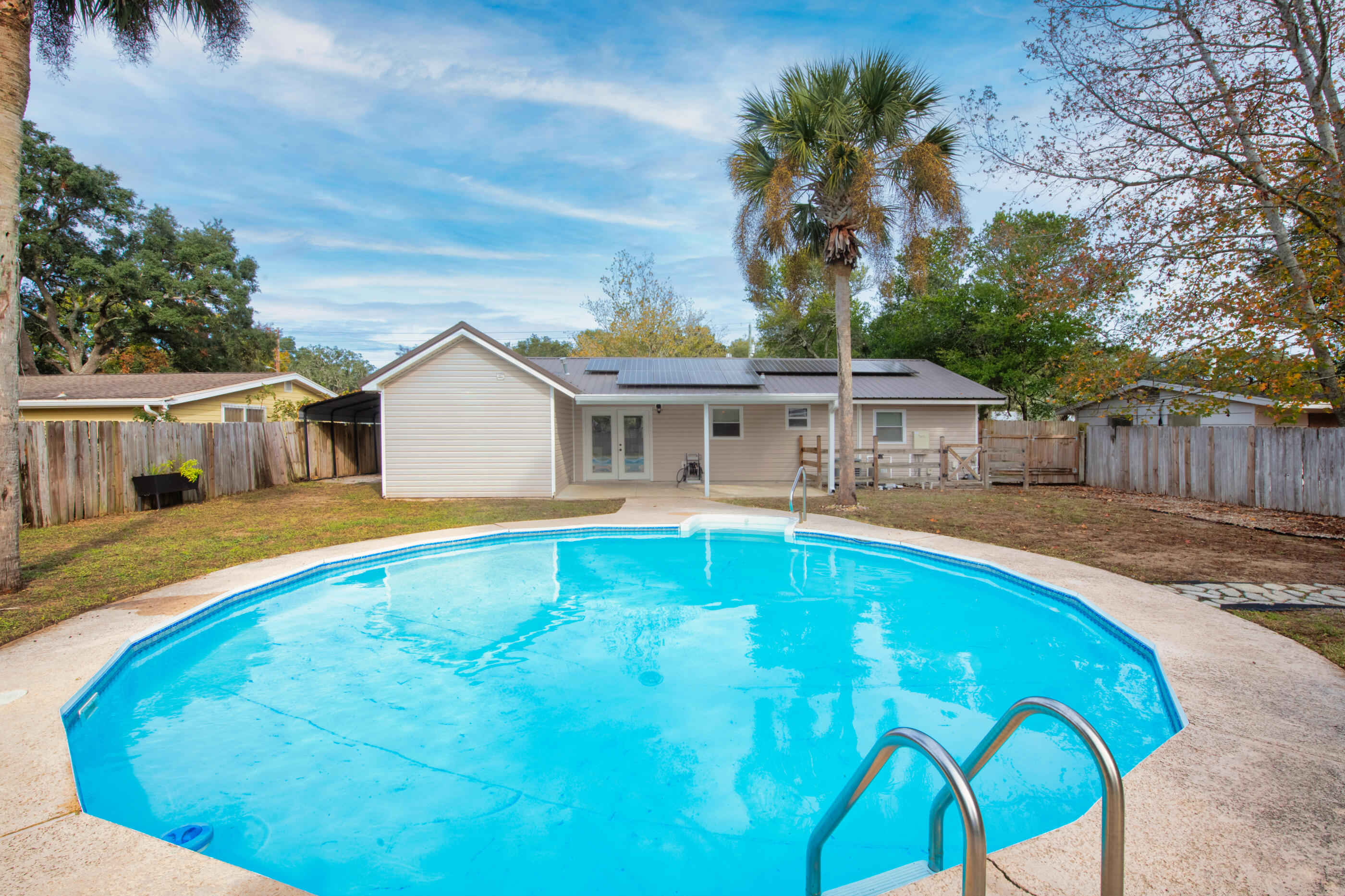 2.75% ASSUMABLE INTEREST RATE available on the purchase of this home!! Welcome to the heartbeat of Fort Walton Beach, where your newly renovated 4-bedroom oasis awaits. Envision life in a home where modern convenience blends with eco-friendly living, thanks to paid-off solar panels and a striking new metal roof. The open floor plan greets you with luxurious LVP flooring and granite countertops, while a smart thermostat adjusts to your comfort at a whisper. Your private retreat boasts a master suite with a large walk-in closet, elegant double vanities, and a vast, tiled shower—your personal haven for relaxation. The split bedroom floor plan ensures privacy and tranquility for all, while the expansive laundry room offers practicality with a touch of luxury. Step outside to your own entertainment paradise: a sparkling in-ground pool and a covered patio set the stage for endless summer days. The large backyard, complete with a concrete pad for cozy fire pit gatherings and a generous storage shed, invites laughter and memories under the stars.

With a double-wide driveway and additional covered parking, your vehicles and toysfrom boats to campersfind their place. And for the beer aficionados, the kitchen's built-in mini-fridge and kegerator elevate any gathering.

Nestled just 15 minutes from Eglin Air Force Base, 10 minutes from the gulf's sugary sands, and within easy reach of premier shopping and dining, this home is a sanctuary in the city's vibrant embrace. Here, you're not just close to the action, you're at the soul of itall with the tranquility of a suburban retreat. Discover the life you've imagined; it's waiting for you here.