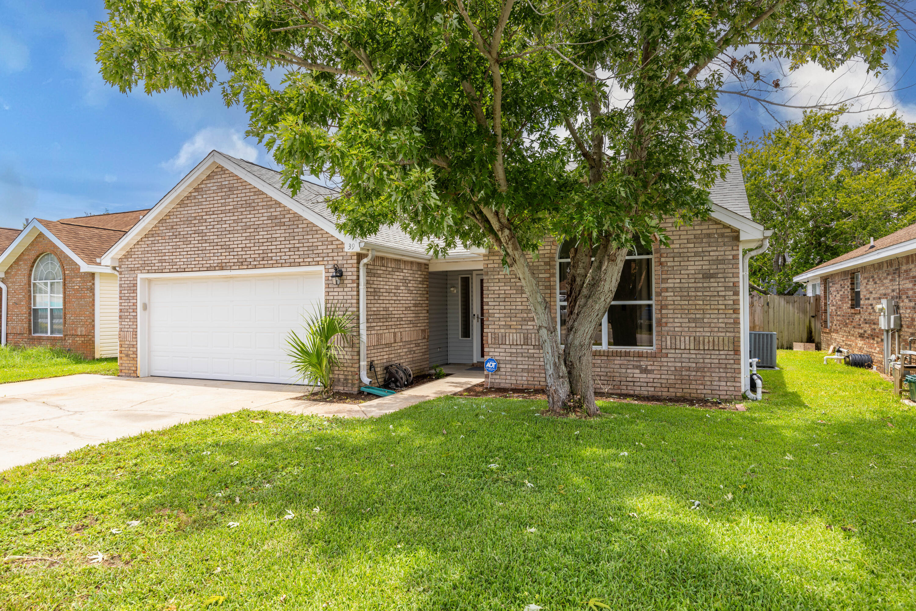 Nestled on a friendly street in the heart of Destin with no HOA, this inviting single-family home offers three cozy bedrooms and a host of charming features. Step inside this freshly painted home to discover a spacious, light-filled interior with a soaring vaulted ceiling that adds a touch of grandeur. The laminate flooring throughout lends a modern, yet cozy feel, setting the stage for stylish living. The split floor plan ensures privacy, while the tasteful updates provide the perfect canvas for your design dreams. Imagine creating your own oasis in the heart of this welcoming space! Outside, a two-car garage and extra-wide driveway offer ample parking, while an enclosed Florida room and covered back patio beckons you to relax and unwind. Perfect for hosting gatherings with friends and family or simply enjoying the great outdoors. The fenced backyard provides a private retreat, complete with a large auxiliary building complete with power making it the ideal space for a workshop or just storing all your outdoor gear. And let's not forget the unbeatable location! With easy access to the elementary school, Destin's best shopping and dining, and the natural beauty of the inland bayous, beaches, and Crab Island, you'll truly have it all. Don't miss out on this fantastic opportunity to call Destin home! Schedule your showing today and start living the Florida lifestyle you've always dreamed of!
