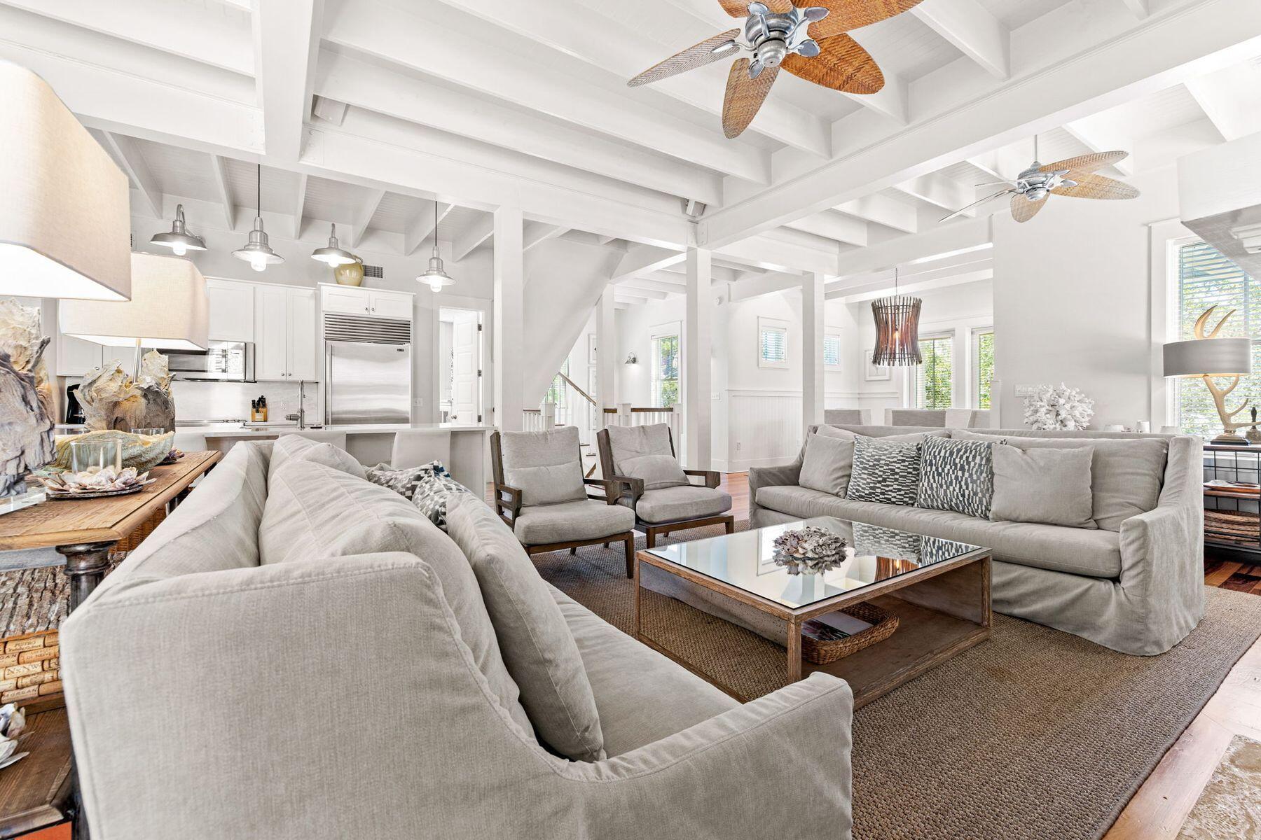 Buffered by greenery, this luxury Florida cottage in WaterColor Phase I sits on a private corner lot. From the covered front porch, it's a short walk or golf cart ride to the beach, private beach club, the boat house and walking trails. Outdoor living is what this home does so well with space to add a pool in the backyard. Four spacious porches, some screened-in, create a haven for laid-back outdoor living. Three floors of fabulous living space include two master suites, one on the main floor and another enjoying superb gulf views from its third-floor location. 
Three additional bedrooms and a bunk room welcome overnight guests when entertaining family and friends. This home features 5 owner's lock-up closets and every bedroom has a walk-in closet. Hardwood flooring and recessed lighting highlight each beautiful living space. On the second floor, the open family room includes a gourmet kitchen, updated in 2021. Heavy beams look down on sleek quartz countertops, new high-end stainless appliances and a Sub-Zero refrigerator. The adjoining bar is ideal for sharing snacks and cocktails before dinner, while a cozy breakfast nook is a great place to start each day. Enjoy family celebrations and entertaining in the dining room before relaxing in the comfortably furnished living room. The feature gas fireplace is flanked by built-in bookshelves and cupboards. Windows look out onto a leafy backyard with a paved barbecue terrace and room for a pool, pending approval. Additional features of the home include five owner's closets, a new water heater, a central vacuum system, surround sound and a spacious laundry room with ample storage. A carport and paved driveway provide ample parking. Room for a small pool where the outside terrace in the back is located.
This beautiful beach house is just two blocks from the private beach and sparkling waters of the Gulf of Mexico. Upscale WaterColor amenities include a spa, fitness center, tennis courts, six resort pools, golf, dining and a lazy river in Camp WaterColor. Seaside, Florida's, pretty restaurants and shops are just minutes away.