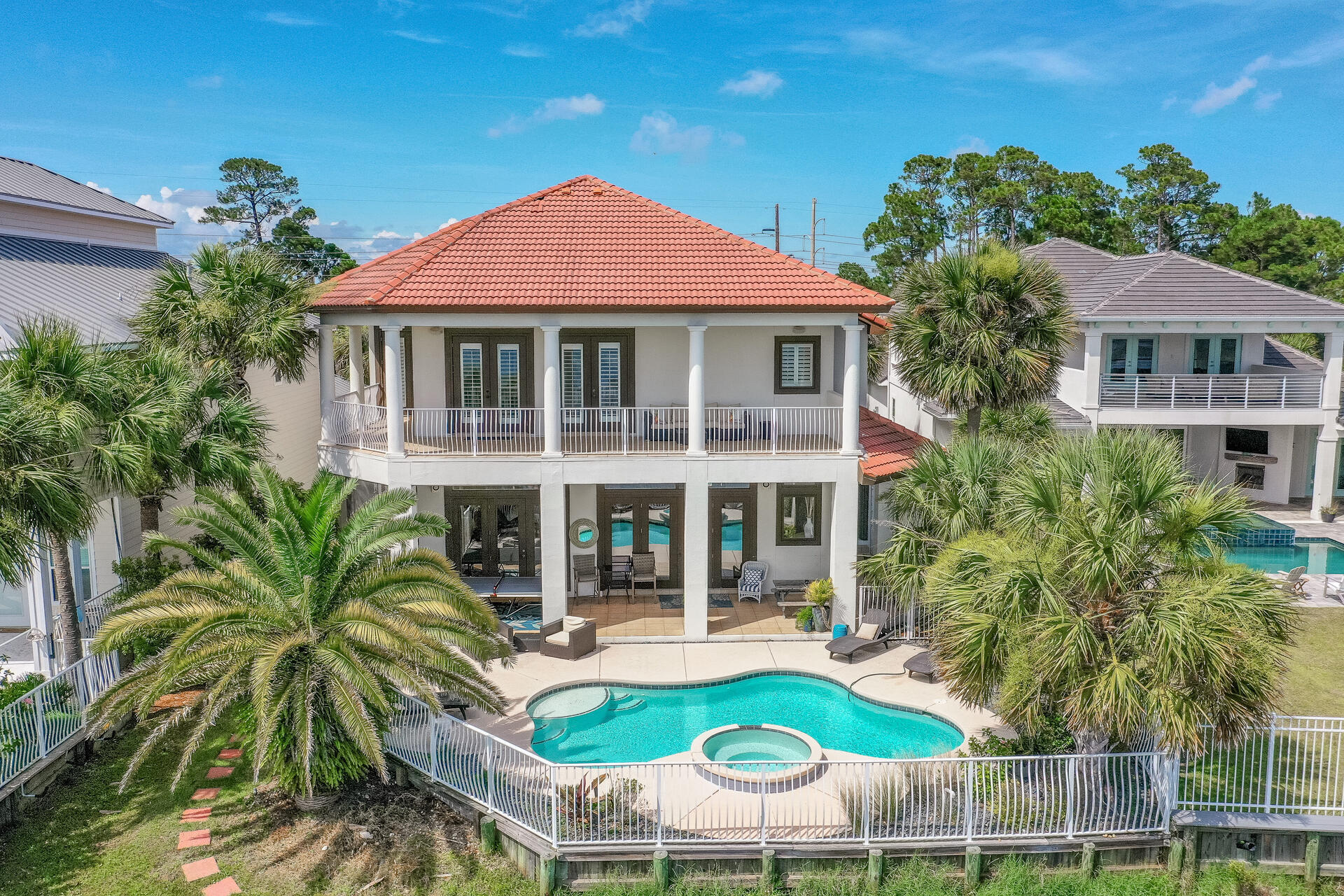 The views from this lakefront home with Gulf views are spectacular and just a short walk to the beach! The current owner has updated this home,  as you enter the foyer you are greeted with water views and an open floor plan ideal for entertaining and family gatherings.  Beautiful pool and spa with LED lighting & a gas heater.  Entire exterior was recently painted with Elastomeric paint.  This home has plantation shutters throughout and a master upstairs and down downstairs, plus a bunk room and large guest room all en suite.  The open floor plan offers easy circulation between spacious rooms that overlook the pool & lake.  Destiny East is a gated community with a large community pool, tennis court, grilling area and playground.