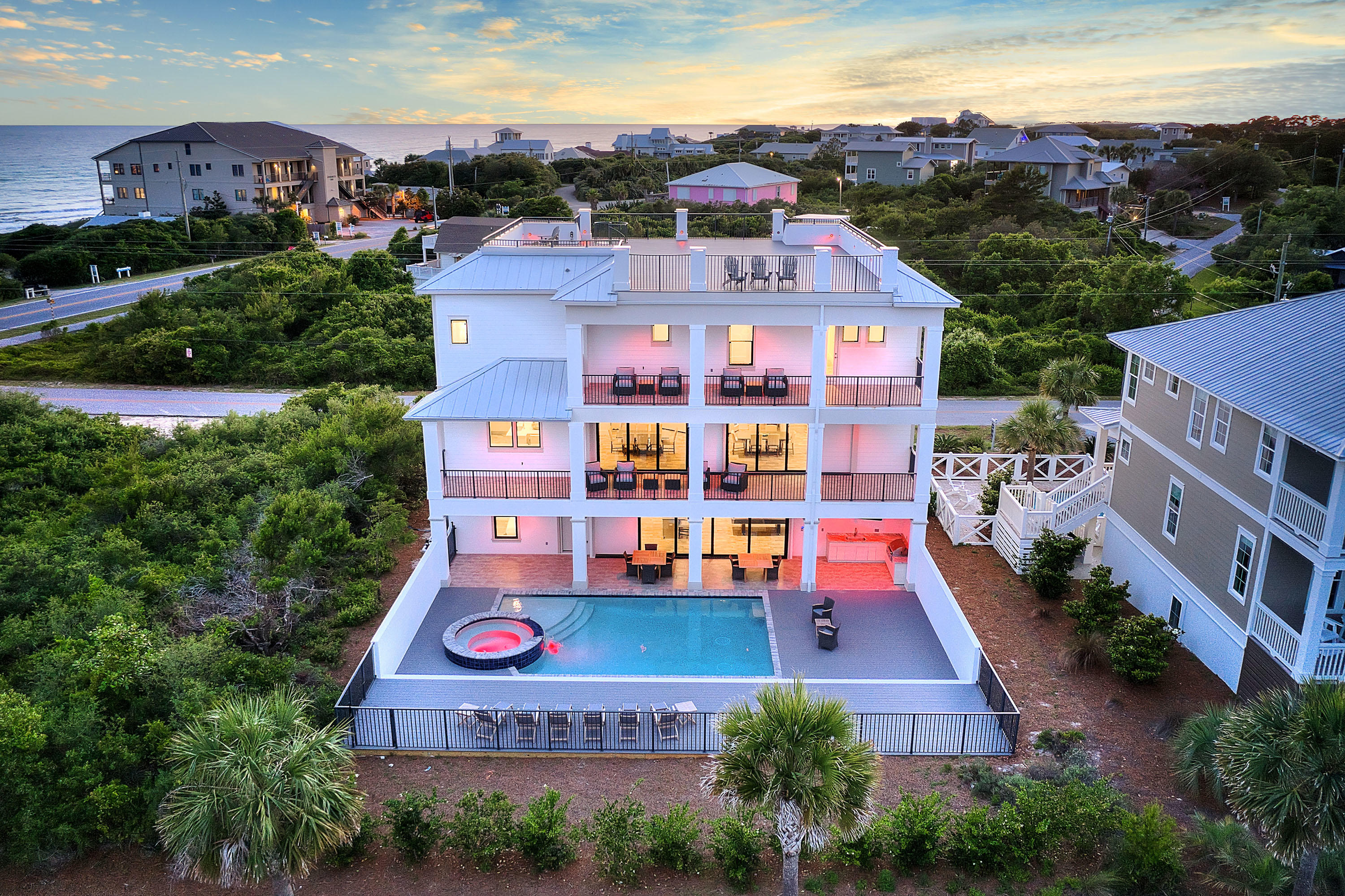 30A location and just steps to public beach access, this newly built home includes gulf views and rental success. Set to top $250K in 2021 vacation rental income, this stunning home features state-of-the-art amenities and a resort-style pool. This 2019-built, 5,688-square-foot home includes a designer kitchen and a rooftop viewing deck, in-home elevator, private pool, and game room. Each space is carefully curated for exceptional living and entertaining. White walls, clean lines, and coastal materials punctuated with sea-inspired hues make the rooms feel relaxed and airy while highlighting the natural beauty outside. The private resort-style pool, includes a spa, spacious deck, covered alfresco dining, and a summer kitchen, elevating the backyard to a gorgeous open-air oasis. Standing four stories high, the rooftop deck offers views of the Gulf of Mexico, the lake, and Dune Allen Beach. Kitchen is impeccably designed to gather and entertain with a large center island with seating for six, a 6-burner Wolf range, quartz counters, a farmhouse sink, and seamless flow into the formal dining room. The entertainment room features a wet bar with seating, a pool table, and immediate access to the pool. All 8 bedrooms and 8.5 baths are design-forward with modern-coastal finishes. "Soleil All Day" will produce over $208K in rental income in 2020, its first full year on the rental market.