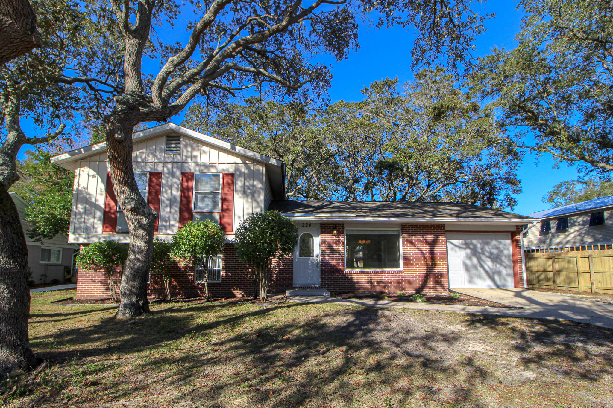 Amazing LOCATION and a chance to add your own touches with some minimal work! Wonderful family home situated on a large lot in the desirable Bayou Woods neighborhood. Spacious living room with large tile flooring and picture window with custom wooden valance. Dining area has tile flooring, chair railing and French doors that lead out to the deck and backyard. Kitchen has beautiful granite tile counter tops, designer lighting, upgraded stainless/black appliances, nice tile backsplash, wainscoting accent wall and a large window over the sink overlooking the backyard. Upstairs is the master bedroom with double closets and a private entrance to a renovated full bath. Full bath has a large vanity, water saver toilet and a window over the bath/shower for nature light. Two additional bedrooms are located upstairs on the front of the house, with good size closets.  Downstairs is a great room for entertaining with plenty of space for lounging and relaxing with the family.  There is a second full bath downstairs with stand up shower and the laundry room is just beyond the bathroom with plenty of room for storing cleaning supplies and folding clothes on the counter tops of the cabinets.  This property could use a little love and care and this house would make a beautiful family home nestled among the live oak trees in the middle of Fort Walton Beach.  If you're handy and don't mind some minor work, this is the place for you!!