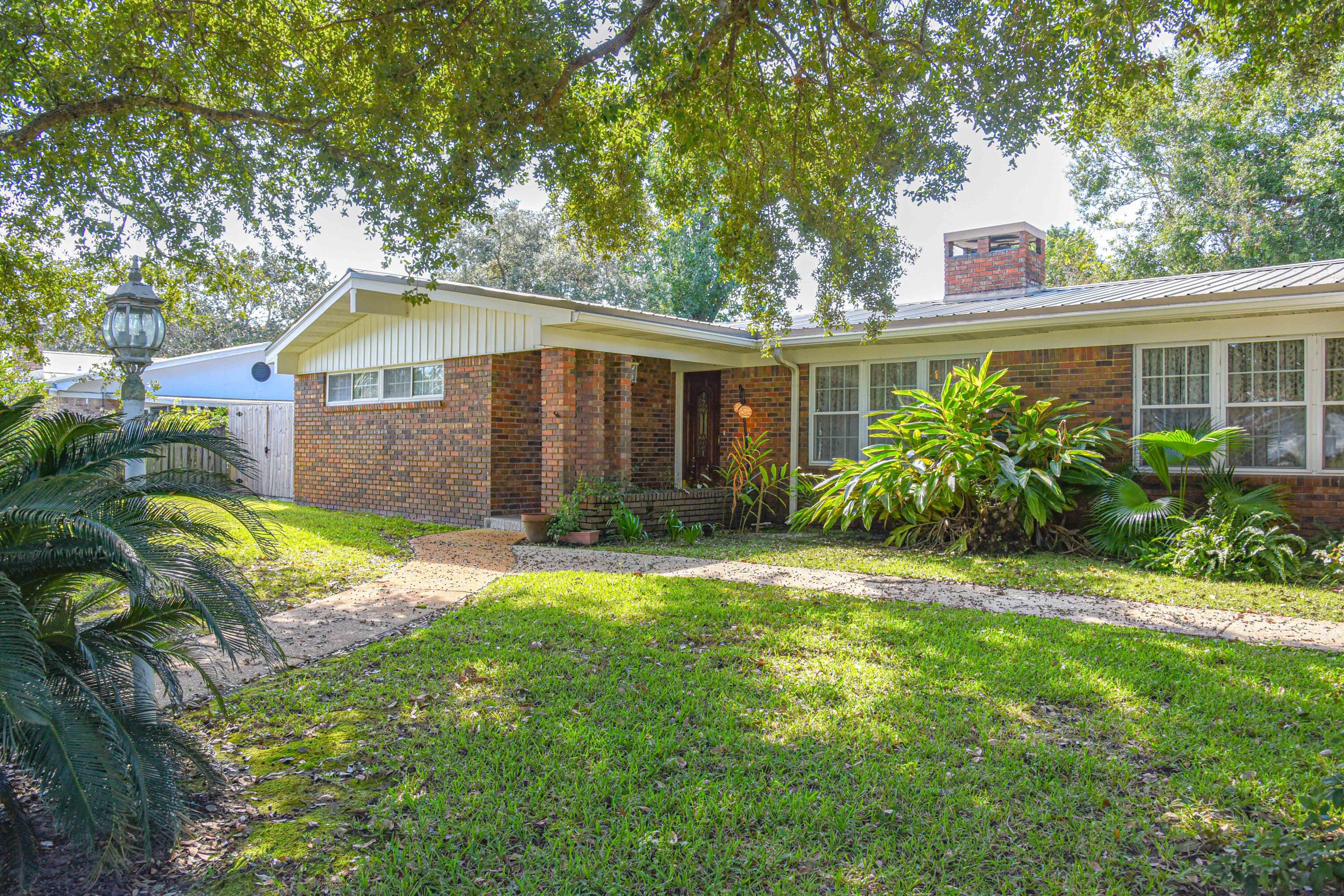 This large, charming, 4 bedroom home will take you back to the good ol days when there were formal living rooms, dining rooms and a large and open family room attached to the kitchen!  There is a dual fireplace that opens to both the Living Room and the Family Room.  AND... there is a bonus room with a cedar closet and a pull down Murphy bed. The 4th bedroom has an exterior door and bath (perfect for an in-law or young adult).  The HVAC was replaced approximately 4 years ago. Don't miss the wonderfully done Florida room where you can enjoy your morning tea/coffee... unless you choose to sit out on the patio in the shade of the oak tree as you enjoy the crape myrtles, camellias and azaleas.