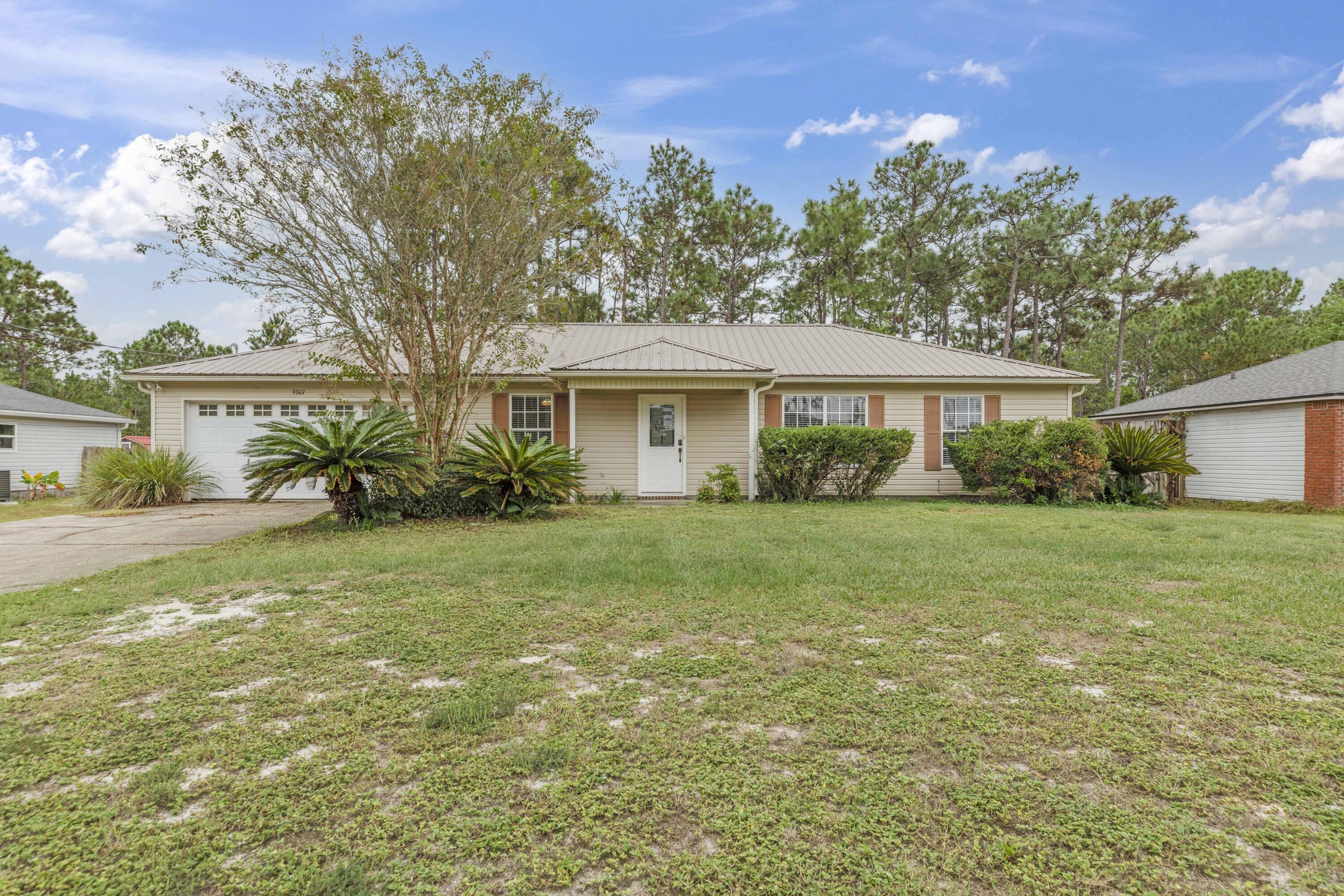 Welcome to 9307 E River! This property is located on over .5 acres and features privacy with a partially wooded back yard. Enjoy entertaining or relaxing on the oversized open deck that connects to the kitchen. Inside this well maintained home you will find no carpet, updated flooring, granite surfaces,  stainless steel appliances and a split floor plan. Come see why this clean, move in ready property should be your next home.