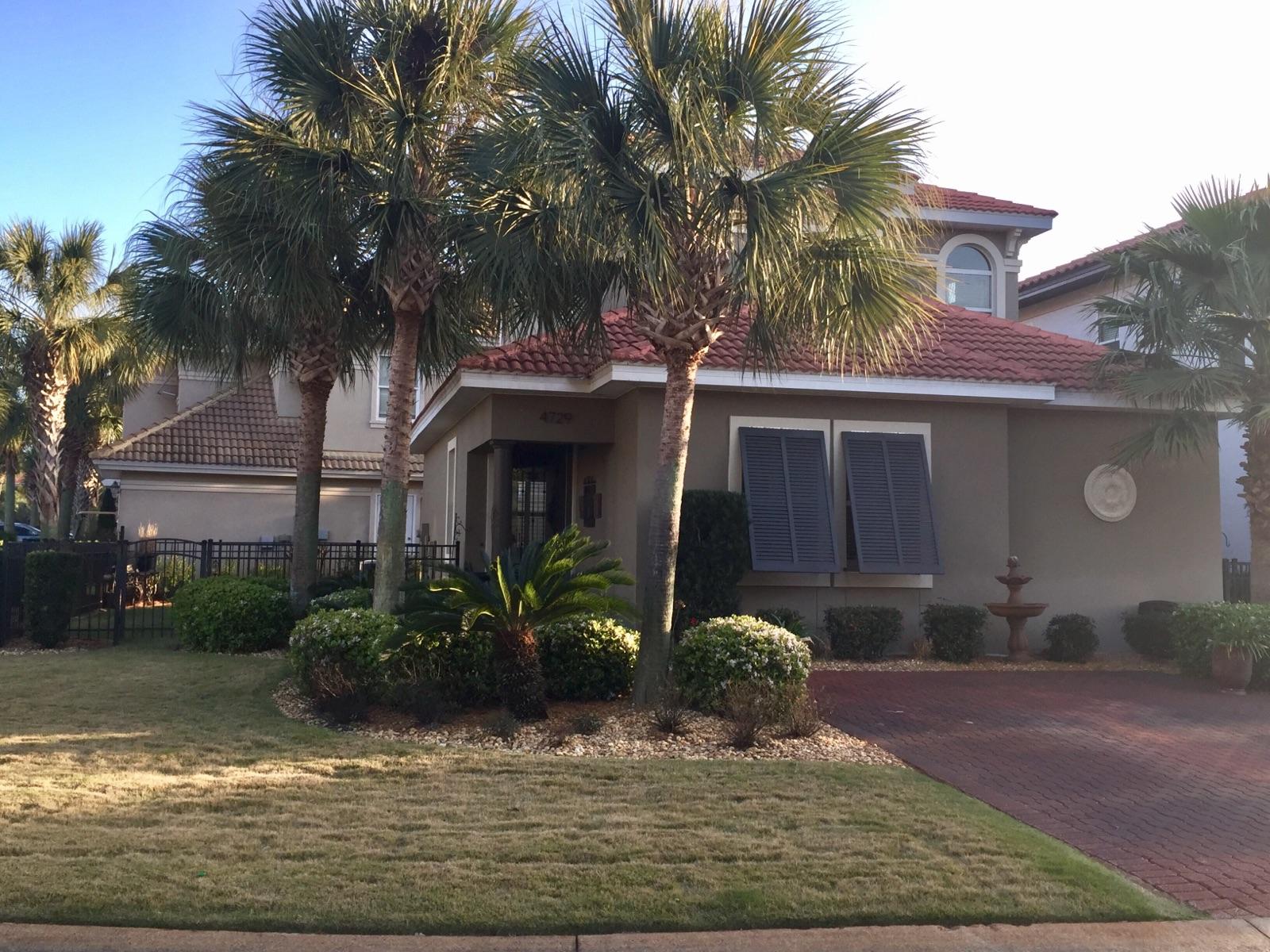 Beautifully decorated and maintained home in a gated community. Fine finishes throughout this home including upgraded light fixtures, stainless appliances, granite, crown molding, high ceilings, ornate iron railing, new all wood decorative corbells, bahama shutters, hurricane shutters, brick paver driveway and walkways. Incredible landscaping with new sod. Master bedroom is downstairs with luxurious master bath featuring a whirlpool tub and walk in shower, and the two upstairs bedrooms share a balcony overlooking the yard. This home has a large corner lot with upgraded iron fencing and lovely landscaping. HVAC replaced 9/2015. Exterior painted June 2013