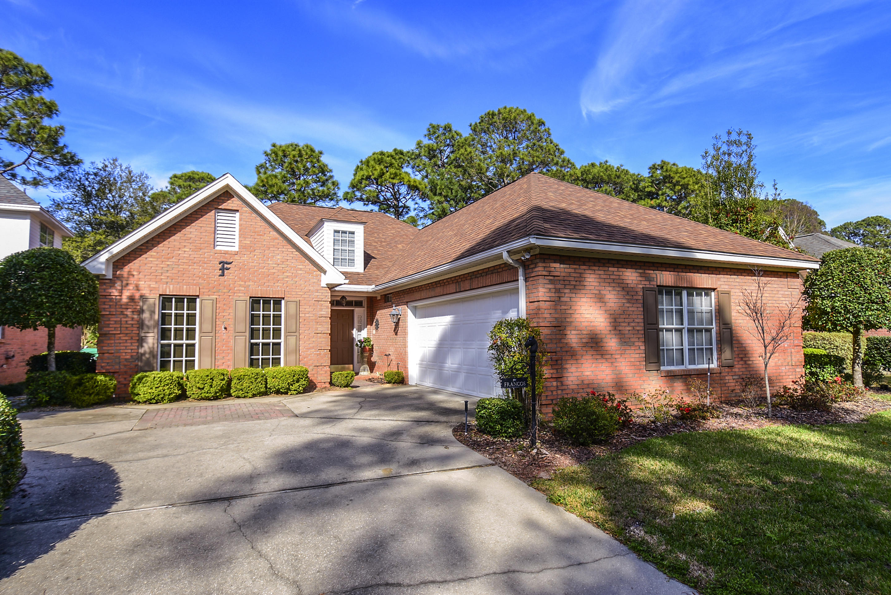 Tasteful and stylish is this 4 bedroom, 2 bath all brick, one-level home that was built to capture comfort and easy living. Many gracious upgrades are immediately noticed when entering. Keeping true to southern tradition, features include smooth ceilings, deep crown and base molding, wood encased windows and a fireplace. Thoughtful planning and professional design by Chateau Builders and upgrades by owners include split bedroom floor plan, open living area concept, walls of windows, wood plank flooring, custom window treatments, granite and stainless appliances. The back yard is a garden to be enjoyed on the large tiled patio ~ panoramic views of the golf course which also provides privacy.
Roof replaced 2014. Don't forget the short drive to beaches, dining, bases & hospitals. See Water filtration system, intercom, washer/dryer & garage refrigerator are not warranted by Sellers and convey 'as is'.