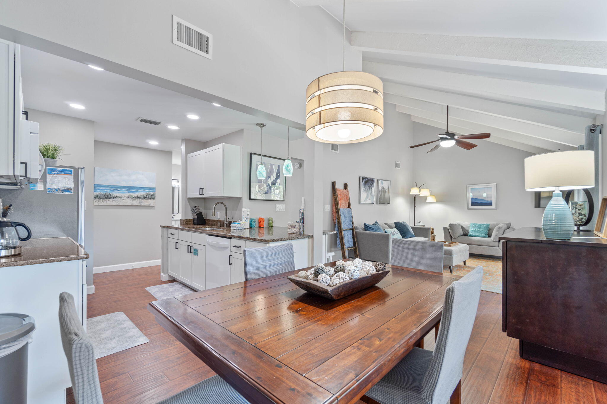One of the nicest furnished & decorated 1 Bedroom Condos within the 300+ acre Gated Community of Seascape with 2000 feet of white sand Beach, lush greens & serene lakes. Conveniently located 50 steps from the Pickleball Courts and 1 of 5 Community Pools. Strategically positioned in a quiet private 2nd floor setting with mature trees. Relax & enjoy the warm Gulf breeze on the expansive 8' x 24' Balcony/Porch while entertaining family & guests. The tastefully decorated & remodeled unit feels new with all the interior upgrades & enhancements including wood-look flooring throughout. Stylish living area & dining area have high ceilings with white exposed wood beams & double sliding glass doors that offer natural light & views of the Porch & magnolia trees. Enjoy the tranquil set relaxing or dining & entertaining in the spacious living areas. A trendy Murphy Bed Cabinet hides a Queen Size mattress to accommodate overnight Guests. The adjacent Kitchen offers ample storage space with white Cabinets, granite countertops, breakfast bar, new 2024 Refrigerator, 2022 Dishwasher, Oven, Microwave & Double Sink. The inviting & fashionable Bedroom has an attractive designer wall showcasing a White King size Bed, dresser, end tables and Closet. The beautifully Remodeled Bathroom has a stunning new walk-in shower & Quartz top vanity, fixtures and an additional vanity outside the bathroom for convenience. The smart design Laundry area has added counter space, storage & a 2023 Washer/Dryer. New Roof March 2024. This location offers ample parking. Amenities include the 2000 feet of white sand Beach, 5 Pools, (2 heated), Pickleball, Tennis, kickball, basketball, Golf Course, Charcoal BBQ areas, Picnic tables and Bike & Golf Cart Rentals. Enjoy causal dining at The Whale's Tail Beach Bar & Grill directly on the Beach. Seascape Town Center has 2 Birds Coffee/Cafe, Mezcal Mexican Grill, Acme Oyster House, Ice Cream Shop, Wine & Spirits & more. Seascape hosts numerous events and functions throughout the year. Conveniently located near Silver Sands Outlet Mall, Grand Blvd Dining & Shopping, Sandestin, Sacred Heart Medical Office & Hospital & more. Primary or vacation home, long term or short term rental. Must see to appreciate! Don't miss this one!