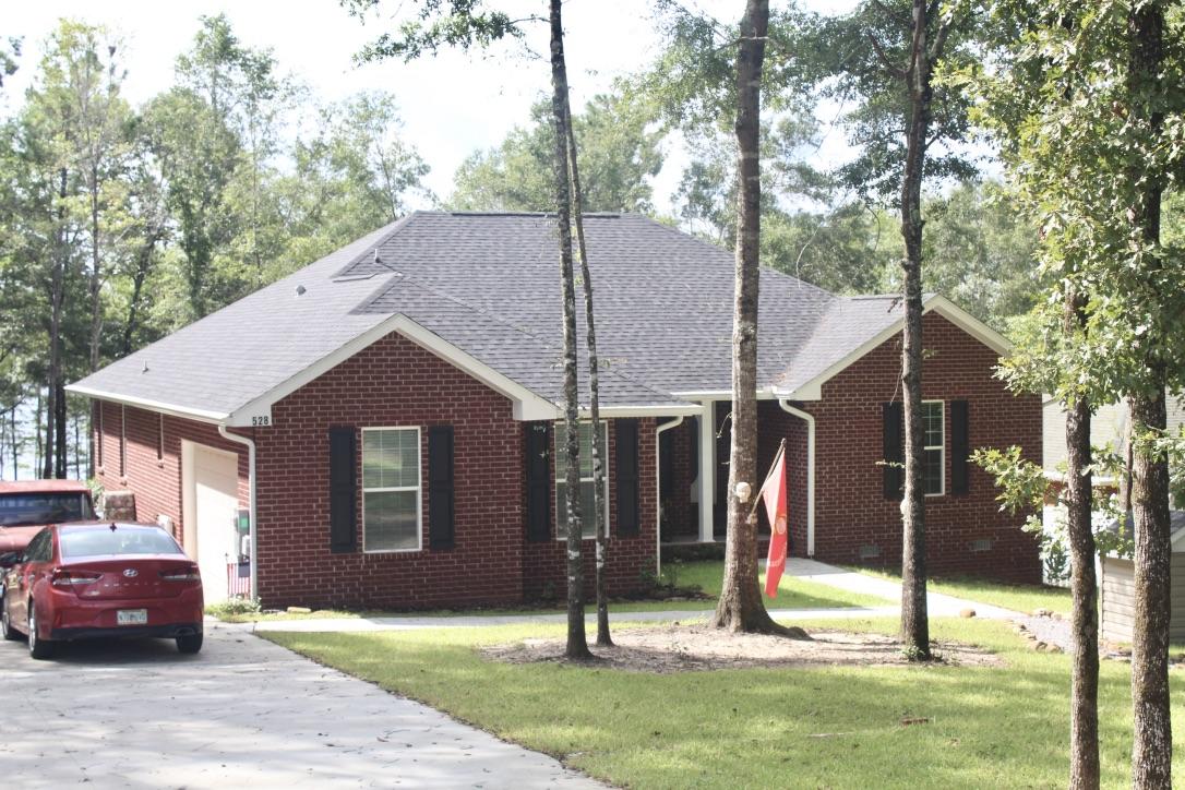 MOTIVATED SELLER! Must see this ''like new'' 2017 custom built brick waterfront home on pristine Blue Pond, one of N. Florida's natural spring fed lakes. Swim, snorkel, scuba dive or fish. The ''like new'' 2017 brick home is custom designed and features a split floor plan, formal dining area, custom kitchen with stainless steel appliances that includes a gas stove, breakfast bar and breakfast nook. The master suite has his & hers walk in closets, double vanity, over sized tub and detached shower. House includes an attached garage. Custom landscaping with french drains. House design offers plenty of windows, lots of light and beautiful views of the lake. New home warranty in place. Hurricane shudders included. Adjoining buildable lot also available. Shown by Appt.
