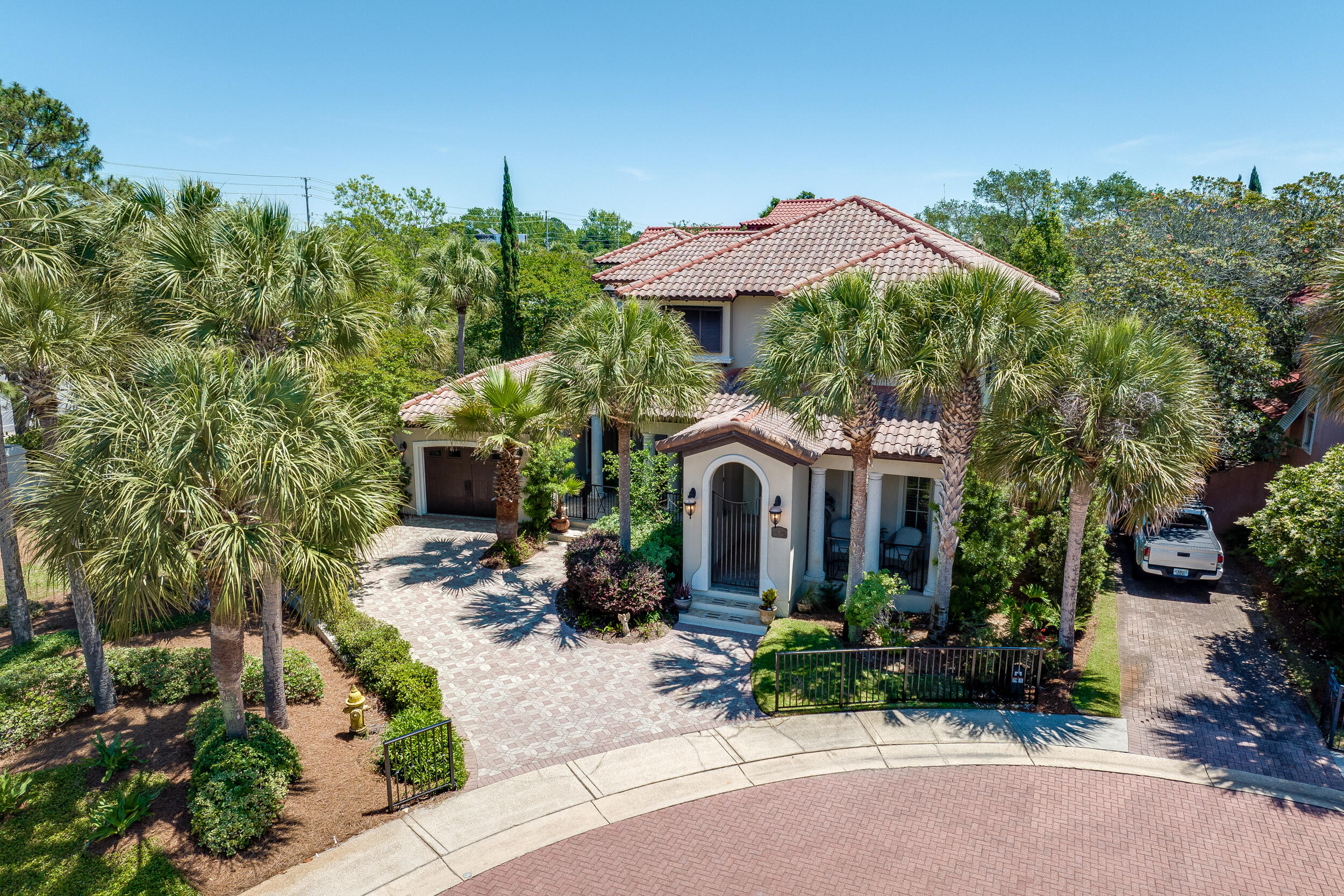 Welcome to 3 Rue Martine, a custom-built home nestled on a cul-de-sac within the prestigious Neighborhood of Caribe in Miramar Beach, FL. This beautiful residence combines sophistication and warmth, creating the perfect retreat for both everyday living and entertaining. As you step inside, you'll immediately notice the fine craftsmanship, from the beautiful millwork to the rounded corners and tall baseboards. Natural light floods the open-concept living and dining areas, where plantation shutters and a well-appointed wet bar set the stage for memorable gatherings. The gourmet kitchen, featuring high-end GE Monogram appliances and a large pantry, is a chef's delight, while the first-floor master bedroom offers a private sanctuary with ample storage and a luxurious en-suite bathroom.