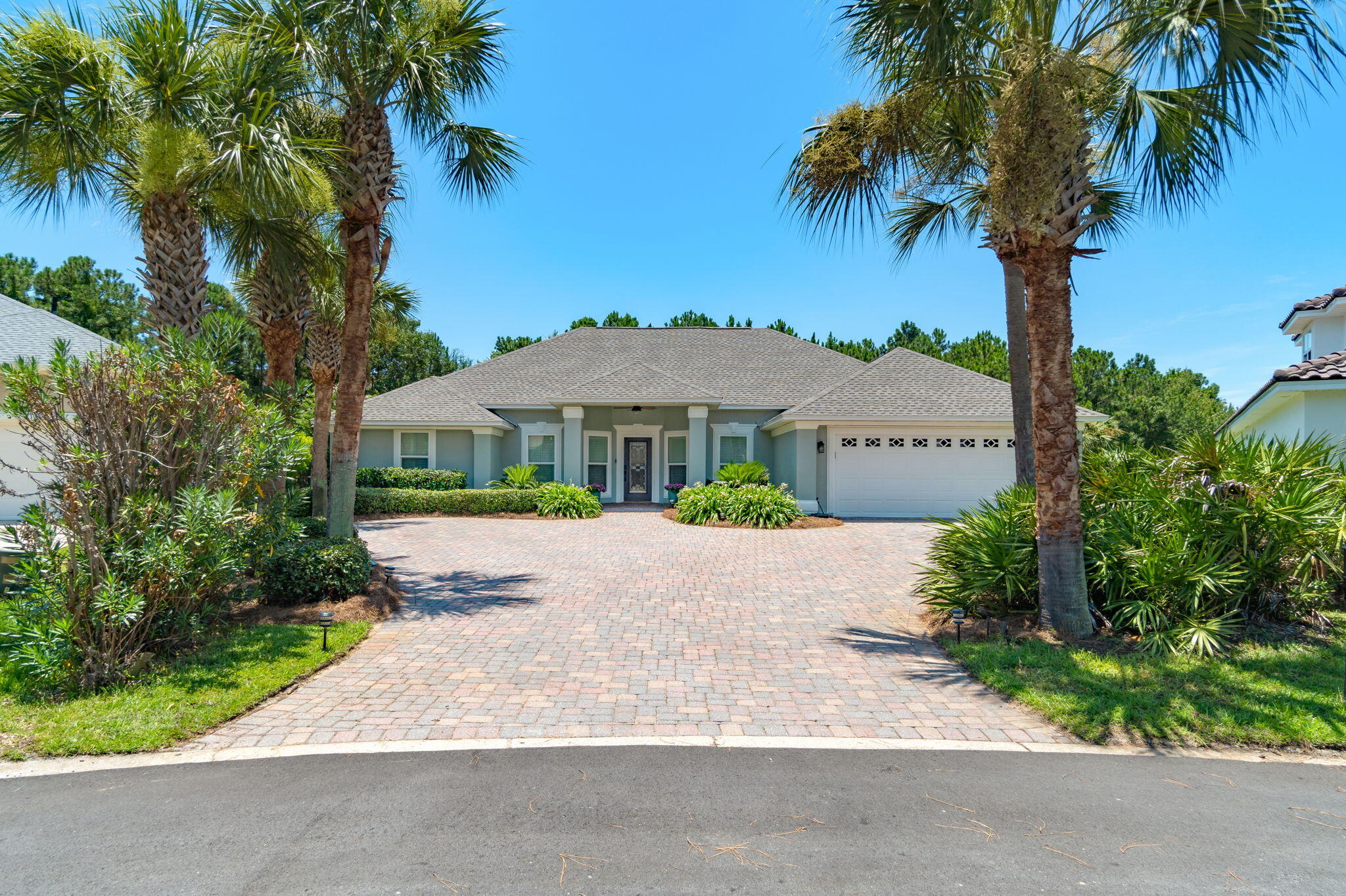 Welcome home to this enchanting lake front beauty in the popular gated community of Emerald Lakes and just minutes to Destin's famous white sandy beaches. Nestled at the end of a street on the largest lot in the entire neighborhood (0.32 acres) with a massive enclosed lanai overlooking the lake you'll love this spacious floor plan with 2,450sqft featuring 4 bedrooms, 3 full bathrooms, an office (currently a man cave), formal dining room (currently a play room), AND an interior Florida room! Pull into the front drive lined with tropical palm trees and seasonally blooming landscaping and you'll love the oversized paver driveway with room for 6 vehicles and appreciate the freshly painted exterior and brand new roof (2022)! No hurricane shutters are needed here, this home features all new impact windows installed in 2020! The covered front porch invites you inside where you'll also find an updated interior that's been completely repainted. Two bonus rooms are on either side when you enter (one of which is enclosed with french doors) and it opens to the spacious family room featuring a vaulted ceiling with all brand new LED recessed lighting and a stunning newly built custom gas fireplace with authentic Old Chicago brick and a custom mantle. You'll love the updated luxury vinyl plank flooring that extends throughout the entire home, as well as the custom plantation shutters, and the split floor plan allows for all the space you need and privacy you want. The owner's suite features a fantastic sized room with a trey ceiling and crown molding overlooking the lake, and an en suite with separate vanities, a jetted soaking tub, walk in shower, privacy water closet, and a huge 5'8 x 14'8 walk in closet. The other three bedrooms on the other side of the home also have ample closets each with closet organizers and two full bathrooms. The kitchen is a great space to enjoy meal time with beautiful warm walnut cabinetry, updated black hardware, granite counters, and stainless appliances with a kitchen bar, center kitchen island, and pantry. The eat in kitchen is also large enough for a table that fits 6! The interior laundry room leads to the garage which has been updated with additional LED lighting and an epoxied garage floor. Water heater was replaced in 2021. Walk back into the living room and step down into the interior Florida room to enjoy an additional space, or continue walking outside to the massive 34'11 x 19'4 enclosed lanai complete with pavers and two exterior doors. One door leads to the fenced in side of the yard complete with providing blueberry and citrus plants, and the other double screen door leads to the rest of the large lakefront lot with plenty of room for a pool! Enjoy relaxing lakeside or pick up your fishing pole and enjoy a lake stocked with large mouth bass! A paver sidewalk winds along the landscaping from the lanai to the side garage door. Enjoy neighborhood amenities including a swimming pool, basketball court, tennis courts, and pavilion area and enjoy being right at the county line conveniently located to the best of Destin and Miramar Beach. The new Destin High School is another great school option! Welcome home!