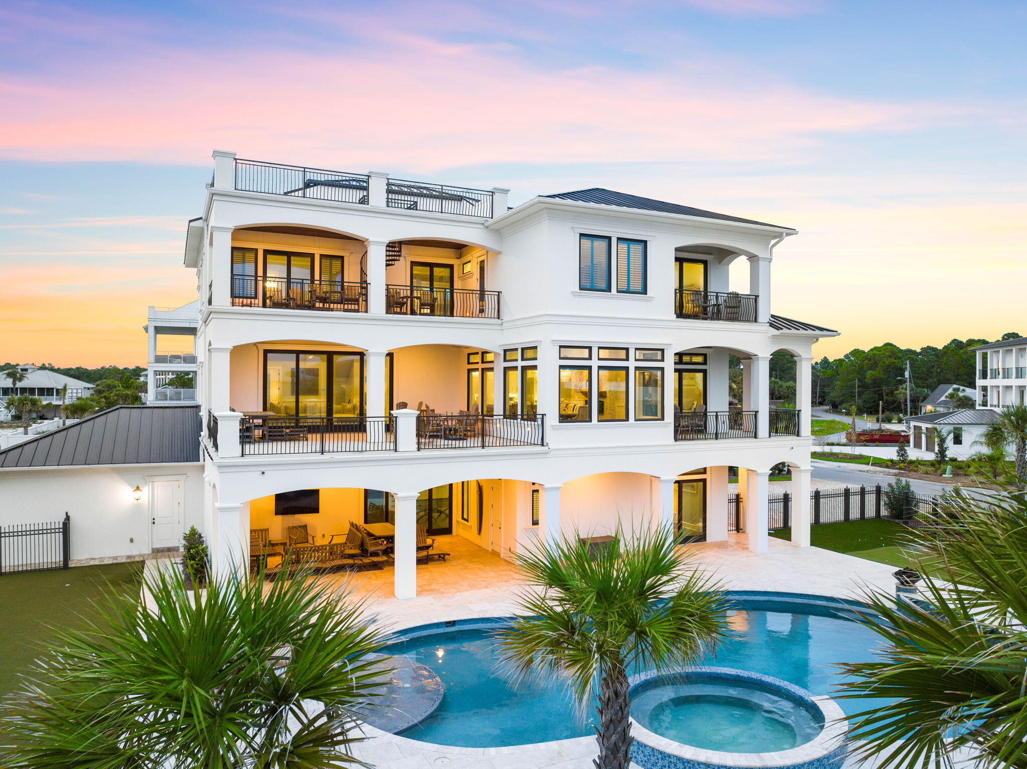 Welcome to 106 E Beach Drive, a coastal haven that redefines luxury living. This remarkable residence has a masterful vertical footprint with three stories of elegant design and a crowning fourth-floor rooftop deck yielding panoramic Gulf views while offering 6,480 square feet of pure opulence. Boasting 6 bedrooms and 8.5 full baths, this property is an embodiment of coastal chic design, nestled on a substantial 1/3 acre lot adjacent to the pristine Gulf of Mexico beaches. Heavily amenitized, notable features include a four car garage, massive resort style pool and adjoining spa, exemplary outdoor living, private movie theatre and in-home elevator. Prepare to be captivated by unobstructed 180-degree Gulf views that grace each level and culminate in the rooftop deck. Please reach out to us today for the cost-to-own and rental projection figures for the property.