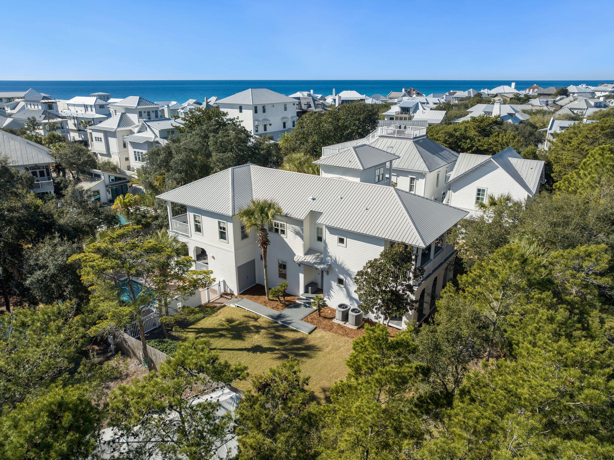 Located in the Inlet Beach community south of Scenic Highway 30A in South Walton County, this beach-style single-family home offers 3,072 square feet of updated living space with 4 bedrooms, 4.5 bathrooms, and a private heated pool just one block from large public beach access and one block from Rosemary Beach. The property sits on a quarter-acre lot and provides convenient access to the coastal amenities that make Inlet Beach one of the most sought-after areas along 30A.

The main living level features an open layout connecting the family room, kitchen, dining area, and primary bedroom, creating a bright and welcoming central gathering space. The kitchen was extensively updated with Thermador appliances including a gas range, quartz countertops, a large custom island with cabinetry under-cabinet lighting, and perimeter cabinets with glass accents. Architectural details such as a rough sawn ceiling beam, recessed lighting, and updated fixtures enhance the open flow between the living and dining areas.

Bathrooms throughout the home were fully renovated with new cabinetry, marble flooring, expanded tiled showers, updated plumbing fixtures, frameless glass enclosures, and modern lighting. Bedrooms feature updated furnishings, recessed lighting, ceiling fans, shiplap accent walls in the primary suites, and custom-built bunk beds that add flexibility for guests.

Recent improvements include a new metal roof installed in March 2025 with a 40-year manufacturer warranty and a five-year workmanship warranty and a new Pentair pool pump. Outdoor upgrades include a new privacy fence, pool gate, paved entry and parking area, landscape lighting, irrigation system with groundwater well pump, a Trex boardwalk at the rear of the home, and a new outdoor shower. 

The location provides quick access to dining, shopping, and coastal destinations throughout Inlet Beach, Rosemary Beach and Scenic Highway 30A.

With its extensive updates, flexible multi-level layout, private heated pool, ample driveway parking and immediate proximity to public beach access, the home is well suited for a primary residence, second home, or investment property with rental potential of over $260,000 per year.