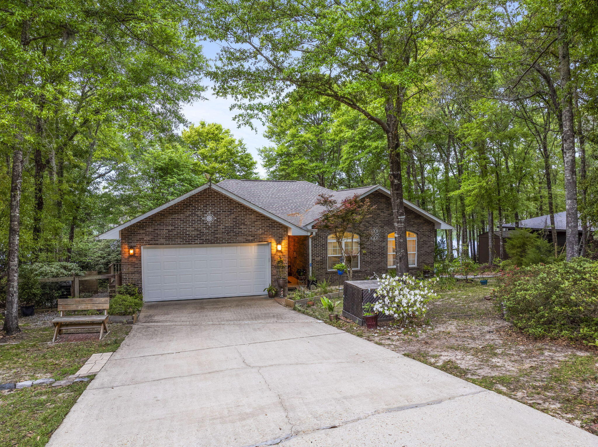 Lakefront Living! Sitting on a lovely half acre lot, this all brick 3 Bedroom 2 Bath home offers gorgeous lake views and your own private dock on Blue Pond -50 acre spring feed lake. Entering the home you'll find 10 ft. ceilings with crown molding and a cozy gas fireplace in the living room. The home features a split floor plan with guest rooms on one side and the generous size master on the other. The large master allows for a sitting area in addition to accommodating king size furniture and has a large walk in closet. The master bath features a double vanity, jetted tub and separate shower. The kitchen with stainless steel appliances opens to a dining area and leads to the screened in back porch. Take your pick of places to enjoy the lake views, the screened in porch, the sun room, or the deck that takes you to the fenced back yard and down to the dock. Come experience the peaceful lake life and all this sweet waterfront home has to offer. Roof and Water Heater 2021-  New garage door 2024 - Dishwasher 2023 - Fridge 2019 - Stove 2022.
