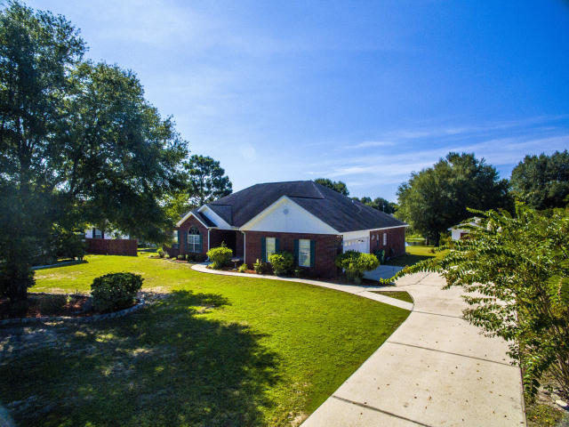 This split bedroom home offers beautiful picturesque view of the lake from the back deck. Home features grand master suite with separate tub and walk in shower, spacious guest bedrooms with walk in closets, and formal living & dining areas complete with sparkling chandelier. The family room has vaulted ceilings with tons of overhead lighting and two ceiling fans as well as a tile accented wood burning fireplace and large mantel. You will enjoy the large florida room that leads out onto the large open deck, perfect for enjoying the view of the lake. Long driveway with side entry 2 car garage plus a storage shed with electric and lots of shelving at the end of the driveway. Sorry NO pets allowed. Any person 18 years old or older must submit separate applications.  Tenants required to carry renter's liability insurance while occupying the home