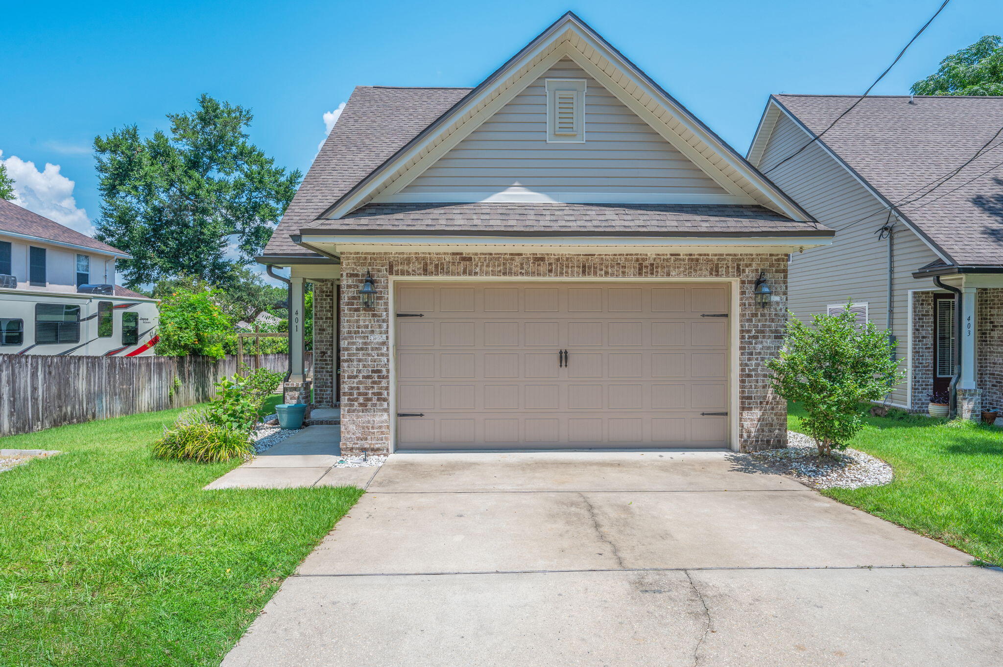 This beautiful four-bedroom, two-and-a-half-bath home is just a few years old and packed with thoughtful upgrades and modern design. Step through the stunning designer glass front door into a bright, open layout featuring luxury vinyl plank flooring throughout the entry, living room, and kitchen. The spacious living area includes recessed lighting, a ceiling fan, and a built-in TV wall mount—perfect for cozy nights or entertaining guests.

The kitchen boasts stone countertops, sleek stainless steel appliances, fresh white cabinetry, a window above the sink, and French doors leading out to the backyard. Plush carpeting and ceiling fans create comfort in all bedrooms, including the upstairs guest rooms and the luxurious primary suite. The primary bath features a dual vanity, large garden tub, separate walk-in shower with glass enclosure, and a generous walk-in closet.

Upstairs, you'll find three additional bedrooms, a full bath with a vanity and shower/tub combo, and a second TV wall mount. The laundry room adds convenience, while the home's window coverings offer a finished touch.

Step outside to your private, fully fenced backyard, where an elevated deck leads down to a concrete patio with a built-in fire pitideal for Florida evenings under the stars. Enjoy the convenience of designated RV/boat parking as well as outside power access for your outdoor lifestyle needs.  This move-in-ready home offers comfort, style, and space in a prime Niceville location.