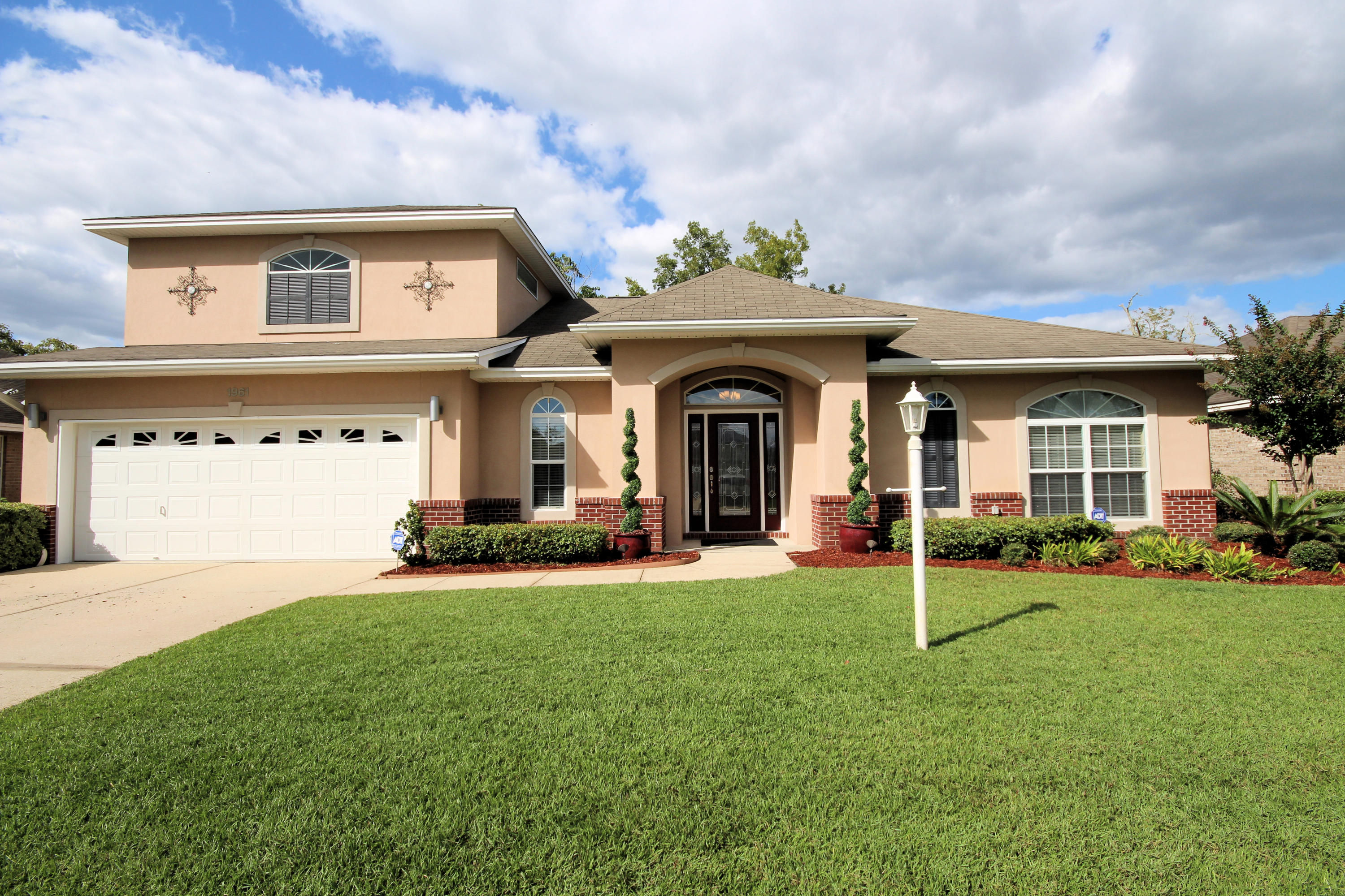 IMMACULATE CUSTOM BUILT ONE OWNER HOME! This 4 Bedroom home begins with Updated Landscaping accented with yard lights on timer. Home features Impact Glass Windows, Renai Tankless Water Heater, Alarm System, Bose Sound System. Enter thru the Front Door which is obscure cut-glass which leads into the foyer, engineered hardwood floors, Wet Bar. Chef's Kitchen with generous Pantry and Breakfast Bar lit with pendant lighting. Kitchen and Bathrooms have Custom Maple Cabinetry throughout home with Euro Stainless Pulls, Black Pearl Granite Countertops in kitchen and Stainless Steel Appliances and SS Backsplash Leads out into the Main downstairs living room perfect for entertaining, which leads out to the outdoor Oasis, Pool Area, where you have your own private Saltwater Pool with composite decking to surround. Natural Gas Quick Connect/ Disconnect for your  attaching for outdoor cooking.  Master Bedroom Suite is downstairs, with huge Walk-in Shower and Walk-In Closet. Laundry Room is situated centrally. Upstairs is huge Bedroom or Recreation Area with Full Bathroom,  then you walk thru to an additional Bedroom or could be a Office. Walk-in Attic Storage Area located at top of stairs, used for Holiday Closet or Storage Area. Too many features to mention. Schedule  your Private Showing.