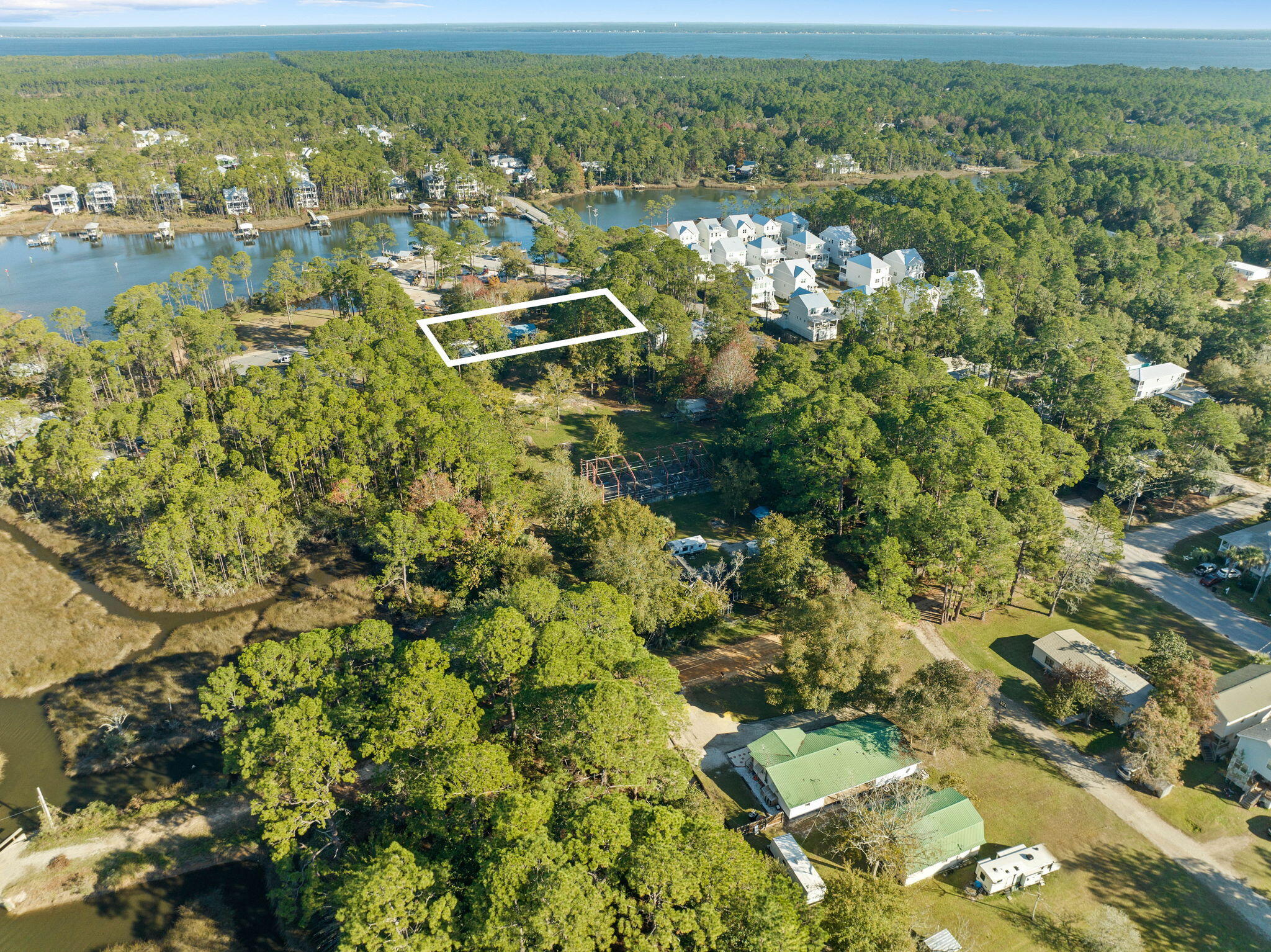 Investor opportunity! Don't miss this prime chance to own a property with unlimited potential. Situated directly across from Cessna Landing Park, this three-bedroom, two-bathroom home rests on a generous .52-acre lot—ideal for expansion or a custom rebuild. In addition to this parcel, 62 W Wilson Street is also available for purchase, providing expanded design possibilities and investment potential. This 1,152 sq. ft. residence includes a screened-in porch and a 24 x 12 workshop, perfect for storage or projects. Boating enthusiasts will appreciate the unbeatable location, offering easy access to Hogtown Bayou, Choctawhatchee Bay, and beyond—without the restrictions of an HOA! Cessna Landing serves as a premier launch point, connecting you to Sandestin, Crab Island, Destin, and Panama City Beach. For those who prefer land-based adventures, head just a few miles south on County Highway 393 to reach Gulf Place, Shunk Gulley Oyster Bar, and the stunning white sand beaches of 30A.This is more than just a homeit's a lifestyle waiting to be embraced. Property being sold AS IS. Information contained within this listing such as square footage, is deemed to be accurate but is not guaranteed. Buyer to verify. Additional Parcel available to purchase MLS #: 970728.