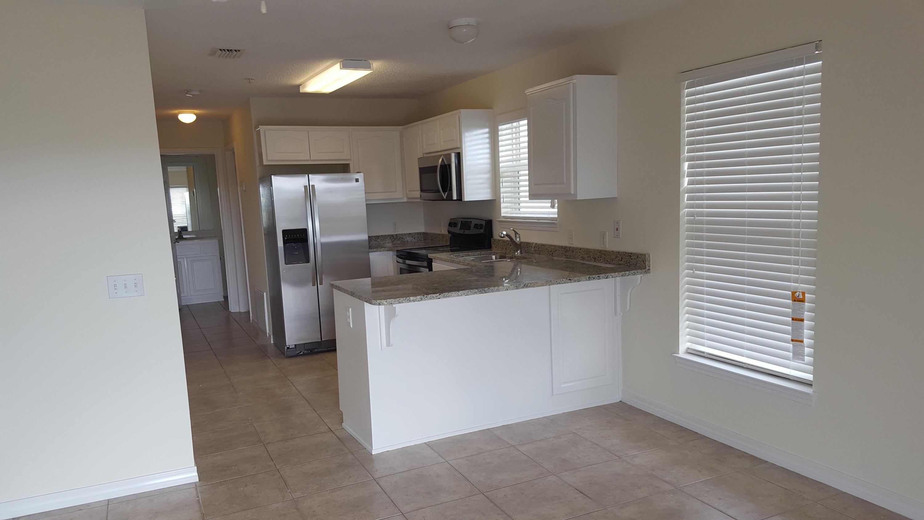 Developer unit!! Like new, completely renovated including granite kitchen counter tops w/under-mount stainless steel sink, all new stainless steel appliances, new faux wood blinds, new sliding glass door blind, new paint thru-out. Beach access is directly south of community. Nice community pool with showers and restrooms. Association provides basic cable, trash and grilling area
