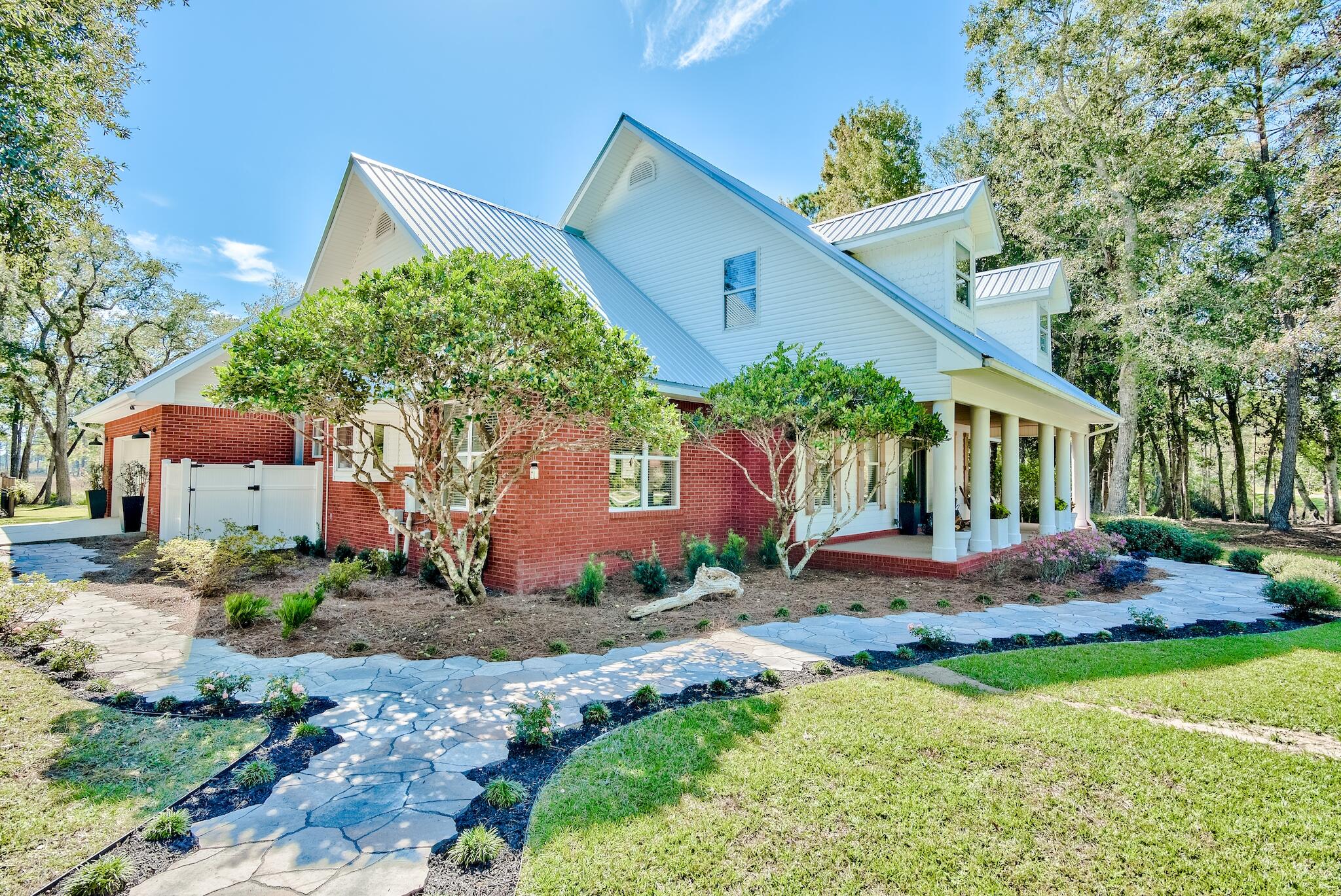Fabulous forever Florida home on this sprawling two acre retreat poised perfectly along La Grange Bayou with gorgeous water views, no HOA, just 20 minutes to the beautiful beaches of 30A, and 1 Minute from Freeport Marina and public Boat Launch! This striking 4 bedroom, 3.5 bath estate sits quietly off the road flanked by mature oaks and an extended private drive leading to a two car garage and one amazing workshop! This property is truly one of a kind! At first gaze, you will appreciate the character of the colonial columns that harken back to porch sitting days of old. Upon entry you will take note of the modern features such as the stunning bright white kitchen with Granite Counters and cooktop island, beautiful breakfast nook with viewing windows,
glazed concrete floors, gas fireplace, Counters and cooktop island, beautiful breakfast nook with viewing windows, glazed concrete floors, gas fireplace, perfectly positioned study office, formal dining room and living room with French doors leading out to an enclosed screened in back porch. This private estate features ground level master with an en suite bath, garden tub, his and her vanities, separate shower and two walk in closets! Continuing along the ground level you will find an additional guest bedroom, full bathroom, and a full laundry area/ mudroom with separate sink, storage, and a half bath! Exterior home features include expansive front and back yards that run along a winding creek bed opening up access to Lagrange Bayou, not to mention fantastic sunset views! Travel to the second level and you will find two spacious additional bedrooms both with walk in closets, separate vanities, and a seating area! Need extra space? You will absolutely love the secret Bonus Room perfect for storage, or finish it for an additional playroom/living area. Last but not least, we must highlight the amazing amount of space available in the separately metered, workshop measuring 40 x 26 with 30 foot awning, RV Hook Up, and a custom dog run. Secluded Florida Living at it's finest, plan your appointment to see this property today! !  Newer roof, age is approximately 3-5 years old, new AC installed 2021, newly hooked up to city sewer.  Sellers have made several improvements to the property. See below:
New garage opener with MyQ remote access installed Mar 2021
New Trane 3 ton 14 seer heat pump installed Sep 2021
Hooked into City of Freeport sewer system replacing septic system August 2021
New chandeliers in kitchen and dining room May 2021
New coach lights at garage May 2021
New ceiling fans in den and master bedroom installed May 2021
Replaced all ceiling vents and exhaust fans May 2021
Replaced all smoke detectors May 2021
Replaced all wall switches and outlets with rocker style May 2021
Updated den, dining room, laundry, screened porch, backyard flood lights and garage switches to WiFi controlled switches (Kasa/TP Link) May 2021. Can be controlled by Alexa voice command, set on a on/off schedule and dimmed. Also can be controlled remotely.
Fresh paint in den, dining room, foyer, kitchen, screened porch and garage Mar - Oct 2021
New garbage disposal Mar 2021
New Elfa/Container Store kitchen pantry shelving and pullouts installed May 2021
New stone paver walkway in front yard and walkway and patio in backyard Oct 2021
This is a must see. ***Buyer to verify all information and measurements***