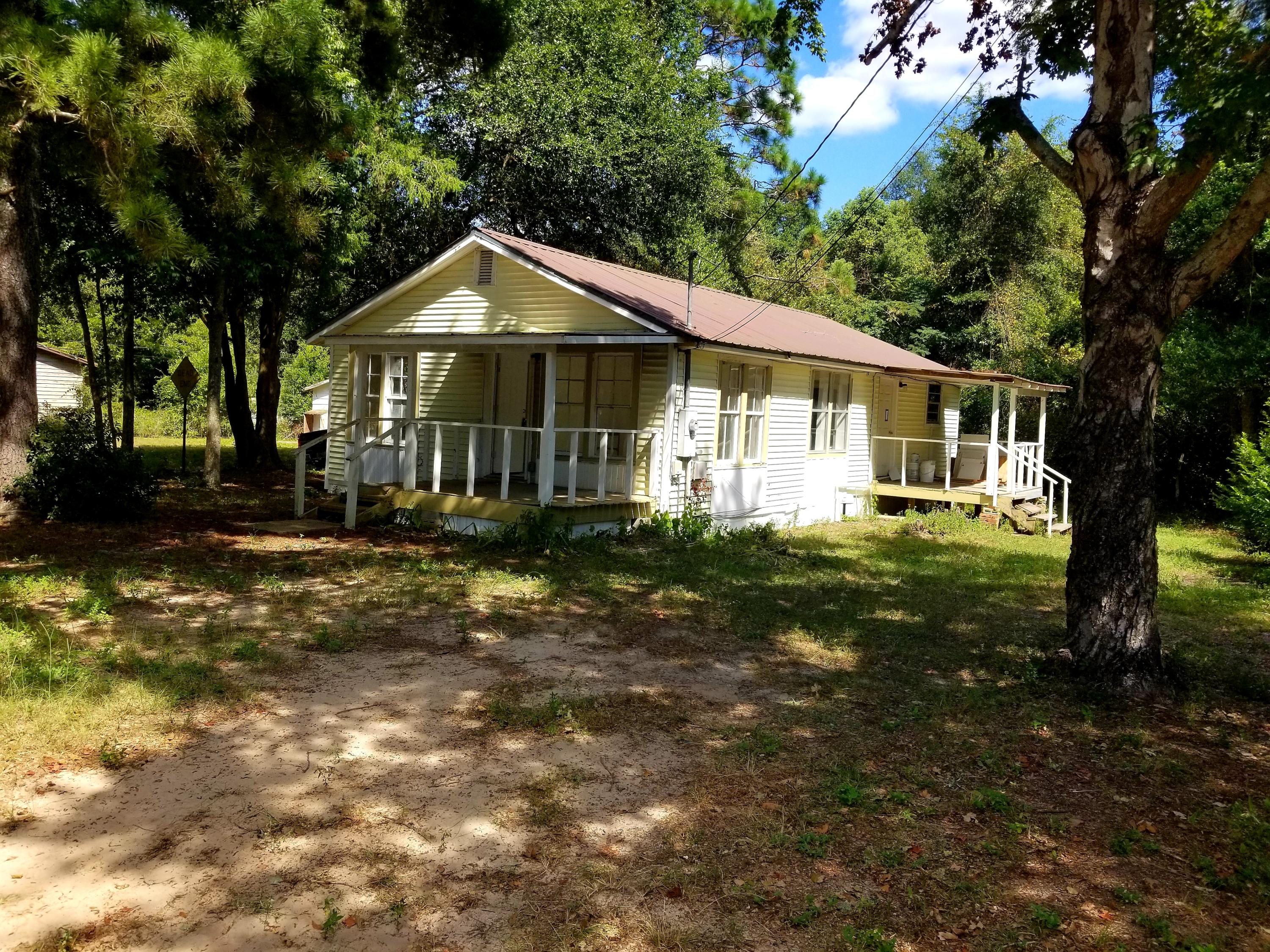 If you are looking for an affordable investment opportunity or a home to put some sweat equity into, this centrally located home will provide endless opportunities. The home has already undergone several key updates such as new electrical, kitchen cabinets, and a newer roof. Call today to schedule your private showing. Home has passed a 4pt inspection for insurance. Want your acre of land? Buy this home, the one next door, and the wooded lot behind them for a special bundled 1 acre deal!