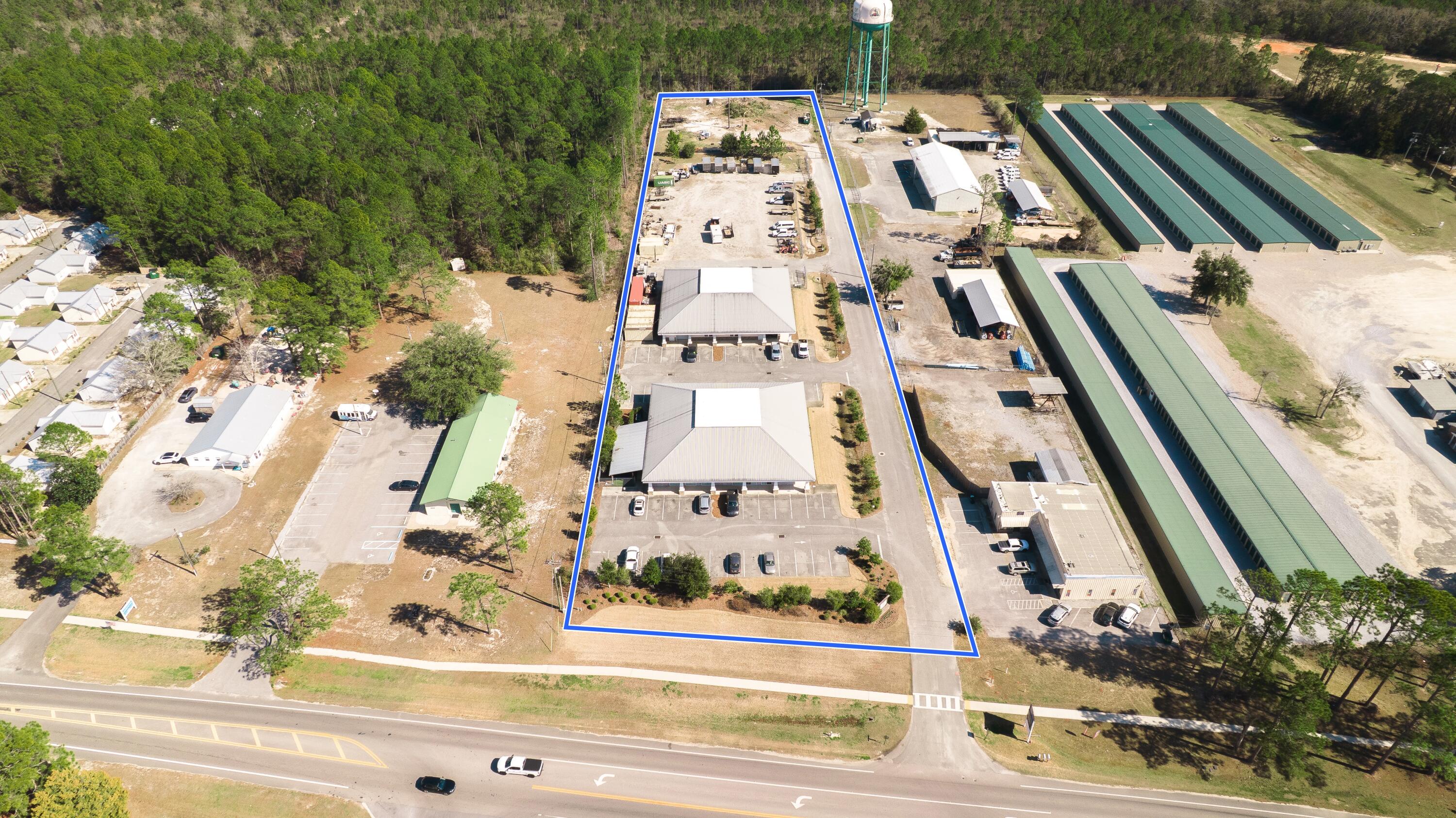 Now offered for lease, this premier office and warehouse campus is situated on ±3.87 acres at 15167 Highway 331 Business in Freeport, Walton County, Florida. Zoned C-1 (General Commercial), the property includes two freestanding buildings totaling ±14,973 SF of gross building area, offering flexibility for a corporate headquarters, professional office users, contractors, logistics operations, and service-based businesses. Building 1 consists of ±8,589 SF of fully finished professional office space across two floors (±6,384 SF first floor / ±2,205 SF second floor). The first floor features two ±2,500 SF suites (A and B) separated by a central common area with shared restrooms, while the second floor includes two suites (C and D) just over ±800 SF each, along with a shared conference room.

Building 2 totals ±6,384 SF and is divisible into Suite E and Suite F, each approximately ±2,750 SF. The flex/warehouse space is separated by a central common area with a shared breakroom and restrooms with showers. The building includes four pass-through grade-level overhead doors (two 9' x 11' rear doors and two 9' x 9' front doors), approximately 17' eave heights, and up to 28' clear height at the center peak, providing strong vertical capacity for racking, storage, or equipment.

Additional highlights include ±2.11 acres of excess land, 65+ surface parking spaces, ±204 feet of highway frontage, secure smart entry systems, on-site camera monitoring, and full utility infrastructure in place.

This offering presents a rare opportunity for single or multiple users to lease scalable, high-quality office and warehouse space along the rapidly growing Highway 331 commercial corridor connecting South Walton to I-10.