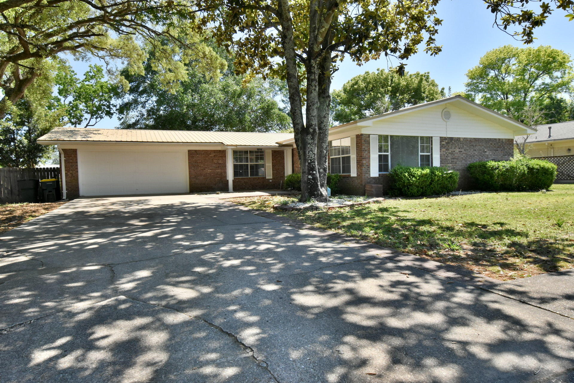 Great Home in the highly desired Kenwood neighborhood in Fort Walton Beach. This 3 bedroom, 2 bath home has two living areas. One off the kitchen and a more formal living area toward the front of the house. Open floor plan with dining area located right by the kitchen. Covered screen porch on the back is great for relaxing. Large master bedroom with two closets, and en suite bathroom. The other two large bedroom are down the hall and share a nice bathroom with lots of counter space. Crown molding, tile and laminate wood flooring throughout the house, & freshly painted make this home move in ready.