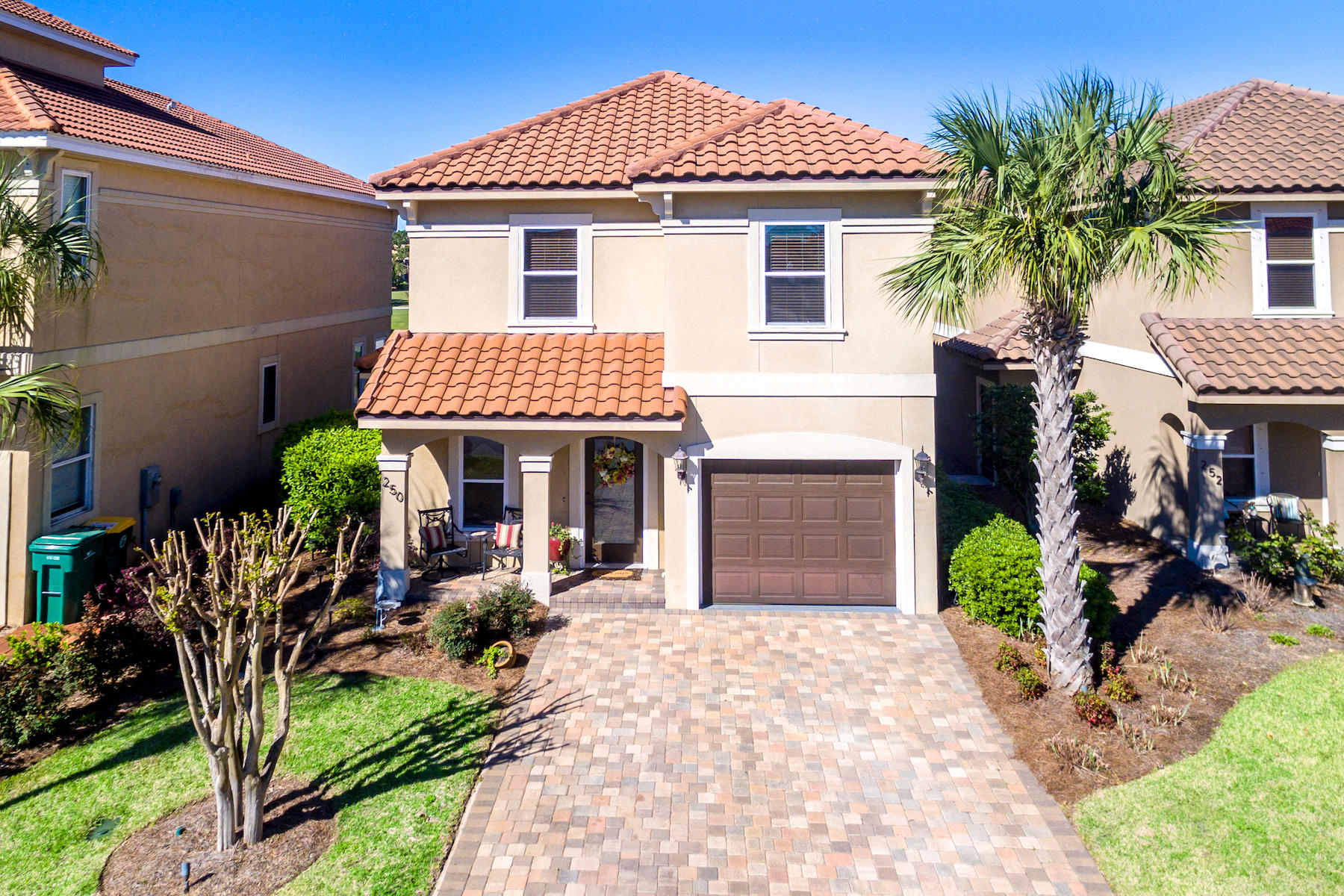 Updated Tuscan style home on the 5th fairway of the acclaimed Regatta Bay Golf Course in gated Calusa Bay. Built by award winning Brent McDowell of Maverick Building Contractors, this home evokes the Tuscan hillside with earth tones, arched passageways, barrel tile roof, pristine hardwoods, travertine tile, trey ceilings, upgraded crown molding, bullnose corners, and plenty of alfresco living. The backyard paver patio and private master suite balcony present sweeping views of the golf course. The open concept kitchen features granite counters, a new stainless steel refrigerator, breakfast bar, soft close cabinets and drawers, and pantry. Gated Calusa Bay offers a community pool and pedestrian walkway to Regatta Bay's semi-private course and onsite restaurant. Additional features include landscape lighting, central vacuum, soft close drawers in baths, sprinkler system, exterior bird protected corbels, and a new high performance W/D.