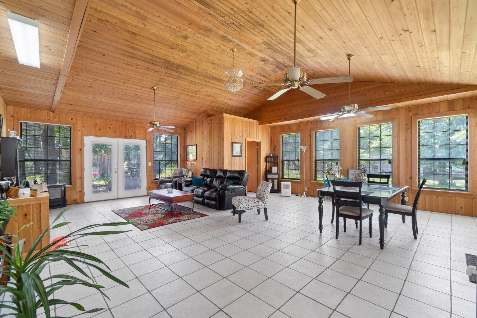 This spacious home in the country has room for you to grow but still connected to the great features and community of Walton County!  This cabin style home has large  living spaces with custom beautiful woodwork throughout the home. This home features 4 bedrooms, 2 full bathrooms, 2 half bathrooms, two living rooms, kitchen and laundry room. The living room is a great space for entertaining and family nights with its custom cedar paneling vaulted ceilings, and many large windows for natural light.  This home has space for your needs and then some.