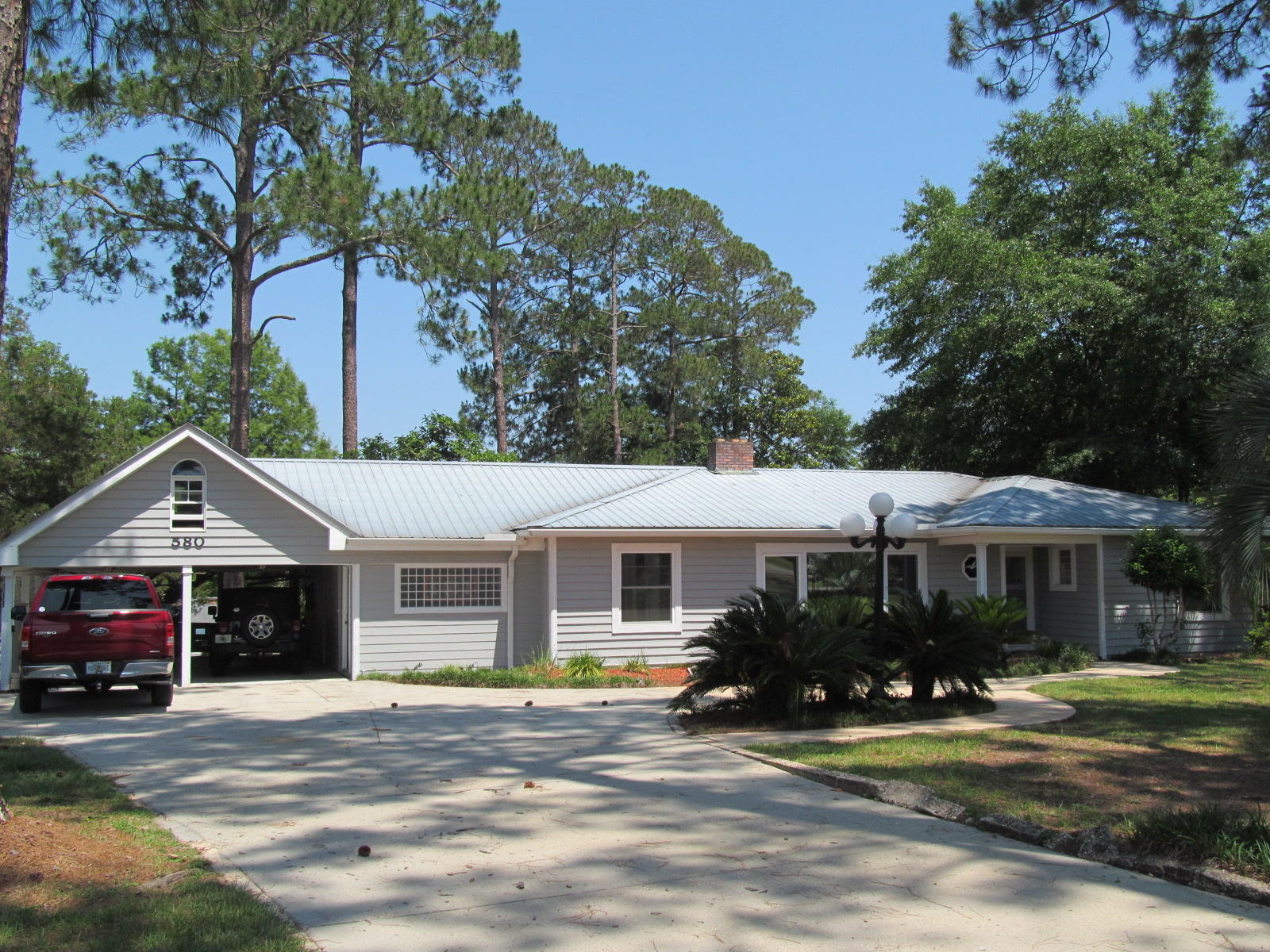 Looking for a fun place to live? Then Look no more! Buy this house & let the fun begin. Fish, water ski, jet ski, entertain in your formal living room or relax in the family room or maybe just sit out on the 13x15 covered deck and enjoy the waterfront view of Back Lake, one of the only lake in the area where you can water ski and jet ski! Talk about your own man cave! WOW.You will love the detached 23x29 workshop with three oversized commercial grade roll up doors. And there is even more.... boathouse with deck and seawall that could serve as a cool artist studio, workshop or just a private little get away spot on the water. Kitchen & master bath renovated in 2009. A/C only 5-6 years old. New windows installed 2012. Roof 10-12 years old. Full RV hookup being sold ''AS IS''