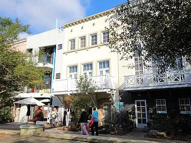Gigi's Getaway townhouse located in Ruskin Place Artist Colony in the heart of Seaside. Lovely quiet park setting. Situated between the architecturally stunning Seaside chapel and the main shopping/restaurant area and, of course, the emerald waters of the gulf coast! Very short walk to the sugar white sand beach. This home is three levels plus spacious roof deck with masonry exterior. Ground level includes retail with half bath that can be converted into an additional 5th bedroom and full bath. Entry hall and staircase provides easy access to and from the adjoining Ruskin Place Park with unique shops. Also on ground level is one bedroom with private bath and private entry. Second level offers two separate but adjacent living areas.  Gulf views from the roof deck. Owner occupied.