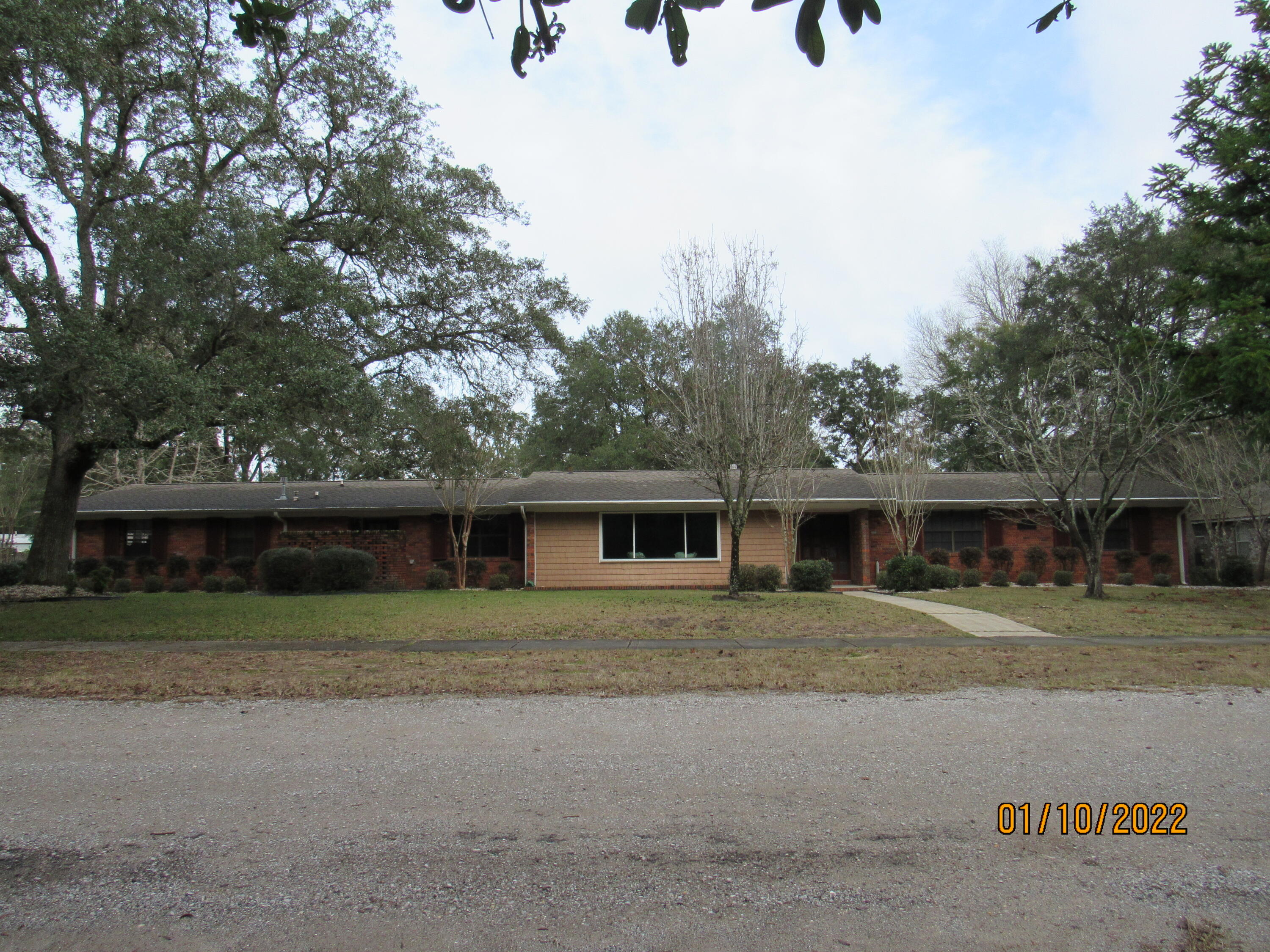 This huge brick home has tons of space - inside and outside, as it is nestled on over half an acre with an attached and a detached garage (with power and water). Inside, there are multiple living rooms with fireplaces (one real, one decorative), a massive Florida room, a spacious eat-in kitchen with a breakfast bar, separate dining area, and a formal dining room, as well. The master has its own access to the Florida room as well as its on en suite. The three guest rooms are nicely sized, and there are two full guest baths (one is off of the laundry room/kitchen). Pets may be considered with prior owner approval and a non-refundable pet fee. No smoking, including vaping.