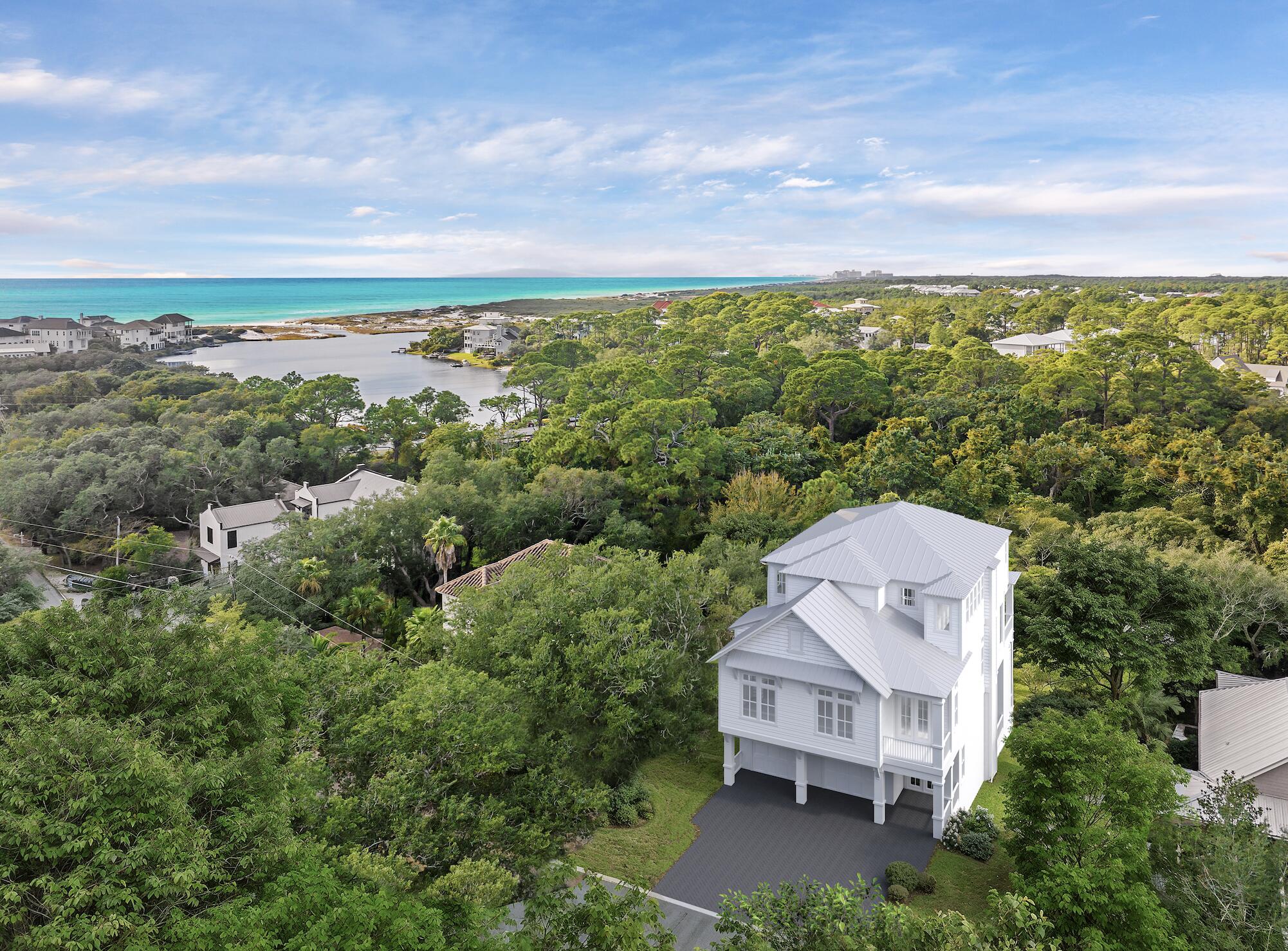 Set west of 30A in one of Dune Allen's most understated enclaves, 91 N Bishop Street brings new-construction precision within minutes of the Gulf. Stalworth Lake is just beyond the property, and the Beach Highlands access point remains one of the rare, uncrowded stretches of sand left on 30A.

The architecture is clean and modern coastal, impact-rated windows, clear lines, and a restrained palette that feels intentional rather than ornamental. Inside, the finishes land exactly where they should: wide-plank floors, custom cabinetry, designer lighting, and a main living level that moves seamlessly from kitchen to dining to outdoor space. The layout is built for both personal use and rental performance. Multiple ensuite bedrooms, a dedicated bunk landing, and generous covered porches make the home feel livable at scale. A private pool and fenced backyard create a resort environment without sacrificing privacy.

From morning coffee runs to Stinky's to evening bike rides along the dune lakes, the lifestyle here is effortless. Restaurants, boutiques, golf, and protected natural coastline sit within minutes. With no HOA restrictions and some of the highest elevation on 30A, this pocket delivers what most beach markets can't: quiet, flexibility, and long-term investment strength.