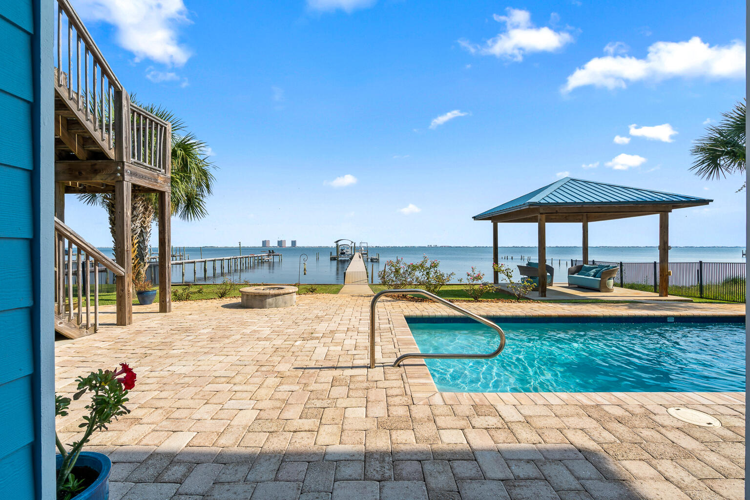 OPEN HOUSE June 21st 10am-12pm.Waterfront luxury in Gulf Breeze-only a short golf cart ride away from Tiger Point Golf Course. 2961 Bay St. offers 5-bedrooms and 5 bathrooms, a dock, pool & elevator. Enjoy breathtaking views of the Intracoastal Waterway, featuring a 250-ft pier with boat slip, lift, and two jet ski lifts, vinyl seawall, and new Trex decking. Enjoy resort-style outdoor living with a private pool and rock waterfall, gazebo, and an expansive balcony with built-in outdoor kitchen, gas grill, sink, and custom cabinetry.
The main living area boasts a chef's kitchen with maple-glazed cabinetry, blue granite countertops, center island, flat cooktop, and built-in oven. The open floor plan flows into a spacious living room with a gas fireplace, surround sound...See more... and stunning water views. Ten-foot ceilings, crown molding, eight-inch baseboards & eight-foot solid-core doors.
The primary suite offers water views, reclaimed wide-plank pine floors, trey ceiling, and a spa-inspired bath with walk-in travertine shower, whirlpool tub, Kohler fixtures, and his-and-hers walk-in closets. You will also find an additional 2 bedrooms, full bathroom with dual vanities plus a half bath for visitors.  
The lower level functions as a complete in-law suite or income producing BNB with two bedrooms, two bathrooms, office, kitchenette, living area, and custom built-ins. Access both levels via a custom iron staircase or a cherry wood-paneled elevator. 
Additional features include:
* Wet bar and entertainment center downstairs
* Cypress ceilings and IPE decking on the porch
* Surround sound inside and on decks
* Hurricane shutters for all windows and doors
* Mahogany front door
* Ample storage throughout
* 2 Huge garages!!
Located just two blocks from a boat launch and minutes from top-rated schools, shopping, and Pensacola Beach. Enjoy southern exposure, cooling Gulf breezes, and unforgettable sunrises and sunsets from your own backyard. This is coastal living at its finest!