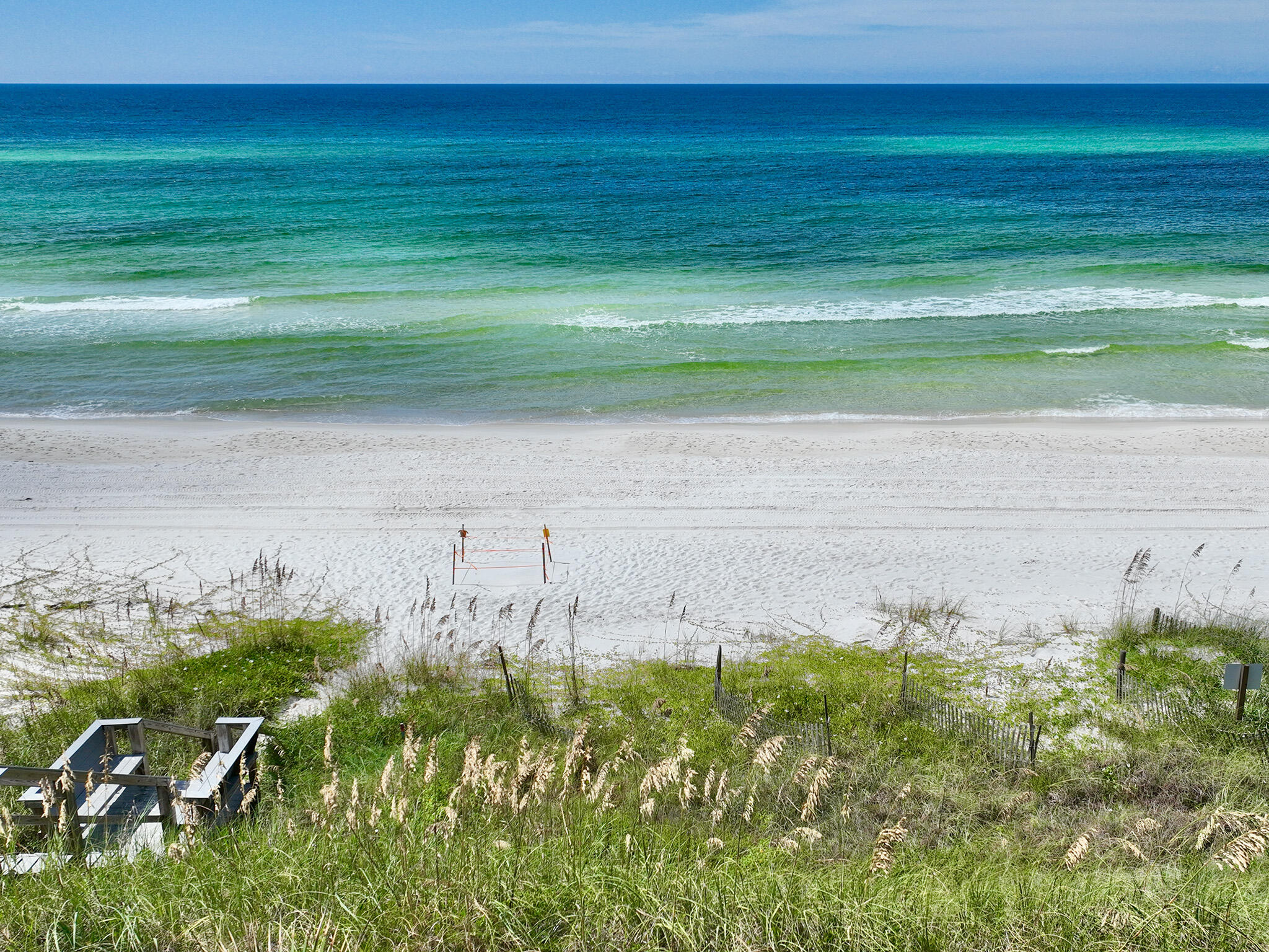 Gulf-Front Gem in Sand Cliffs on 30A
**Rare Opportunity on the Beach**
Get your slice of paradise with this exceptional gulf-front lot in the exclusive community of Sand Cliffs on the Gulf. Located on the east end of 30A close to the renowned Alys Beach and Rosemary Beach neighborhoods as well as the Watersound Club at Camp Creek. This prime location offers unparalleled beauty and privacy with easy access to nearby restaurants and amenities.

**Build Your Dream Home**
- One of the last undeveloped beachfront lots on 30A
- 50' of private beach frontage
- Lot dimensions: 200' deep, 50' wide
- 2650 sf buildable area, up to a two-story structure
- Recently permitted custom home plans included
- Utility impact fees paid and building permit previously issued