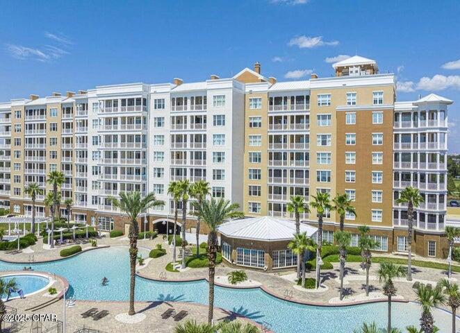 You don't want to miss this 5th-floor beauty at Reflections in Bay Point — where luxury meets lifestyle! Step out onto the private balcony and take in stunning views of the resort-style pool, Grand Lagoon, The Pass, and beyond. It's the perfect spot for morning coffee or evening sunsets. Inside, you'll find a spacious kitchen with granite countertops, stainless steel appliances, and plenty of room to entertain. Tile flooring runs throughout the main living areas, with cozy carpet in the bedrooms. The guest bedroom features a convenient Murphy bed, offering flexibility and functionality. Enjoy top-tier amenities including a lagoon-style pool, hot tub, fire pits, grills, an owner's lounge, and the Serenity Spa right on-site. Short-term rentals are allowed, making this an ideal investment. or full-time residence. Close to golf, dining, and water activities  it's resort-style living at its best!