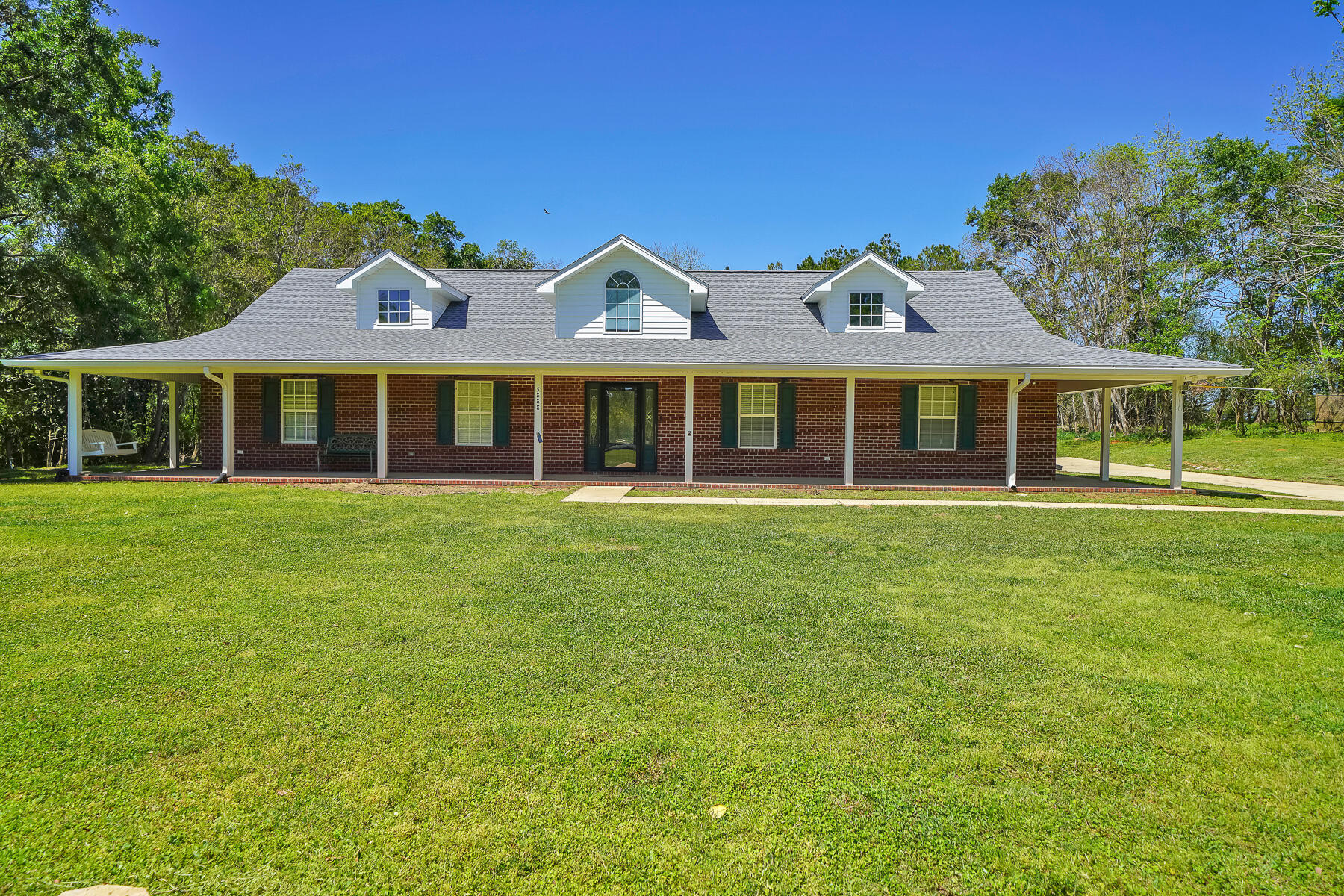 Gorgeous Brick Ranch on 2 acres with expansive covered front porch and BRAND NEW ROOF.  Home boasts 4 bedrooms plus an Office with Murphy Bed. Enter foyer to find open concept living-dining and kitchen with cathedral ceilings. Split bedroom floor plan with 3 bedrooms on one side and Master with en suite bath on the other. Large granite counter wraps around the kitchen featuring stainless appliances.  Wood flooring throughout.  Two doors flank the gas fireplace and lead to large 2 acre yard.  Trees line the back end of the property.  Handy Storage building and workshop with power. Side entry double garage leads to laundry room and then kitchen with large pantry. Home wired with camera system and high speed internet. Hybrid tankless/tank water heater. Country Living at it's Finest!